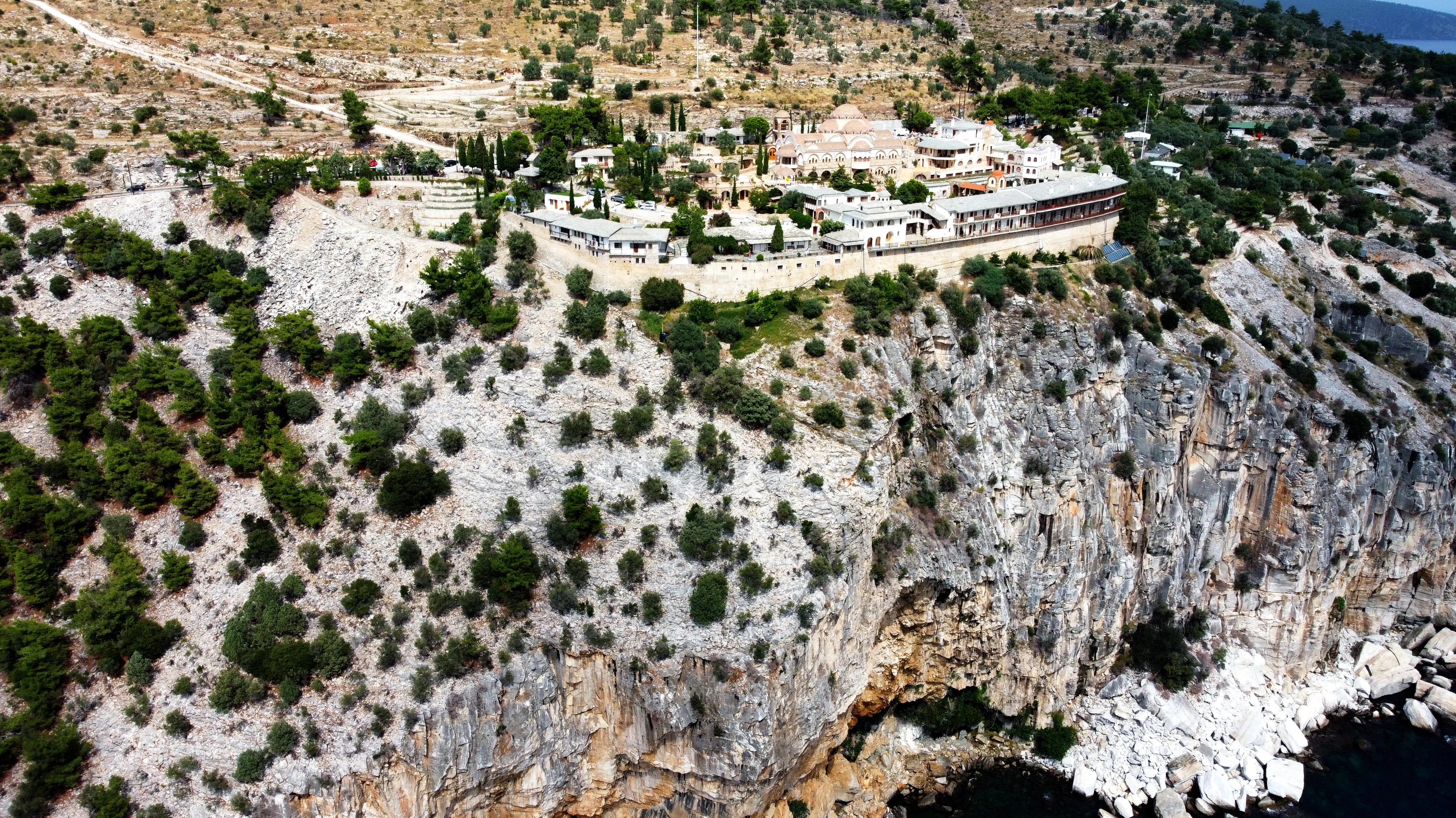 a large building on a rocky hill