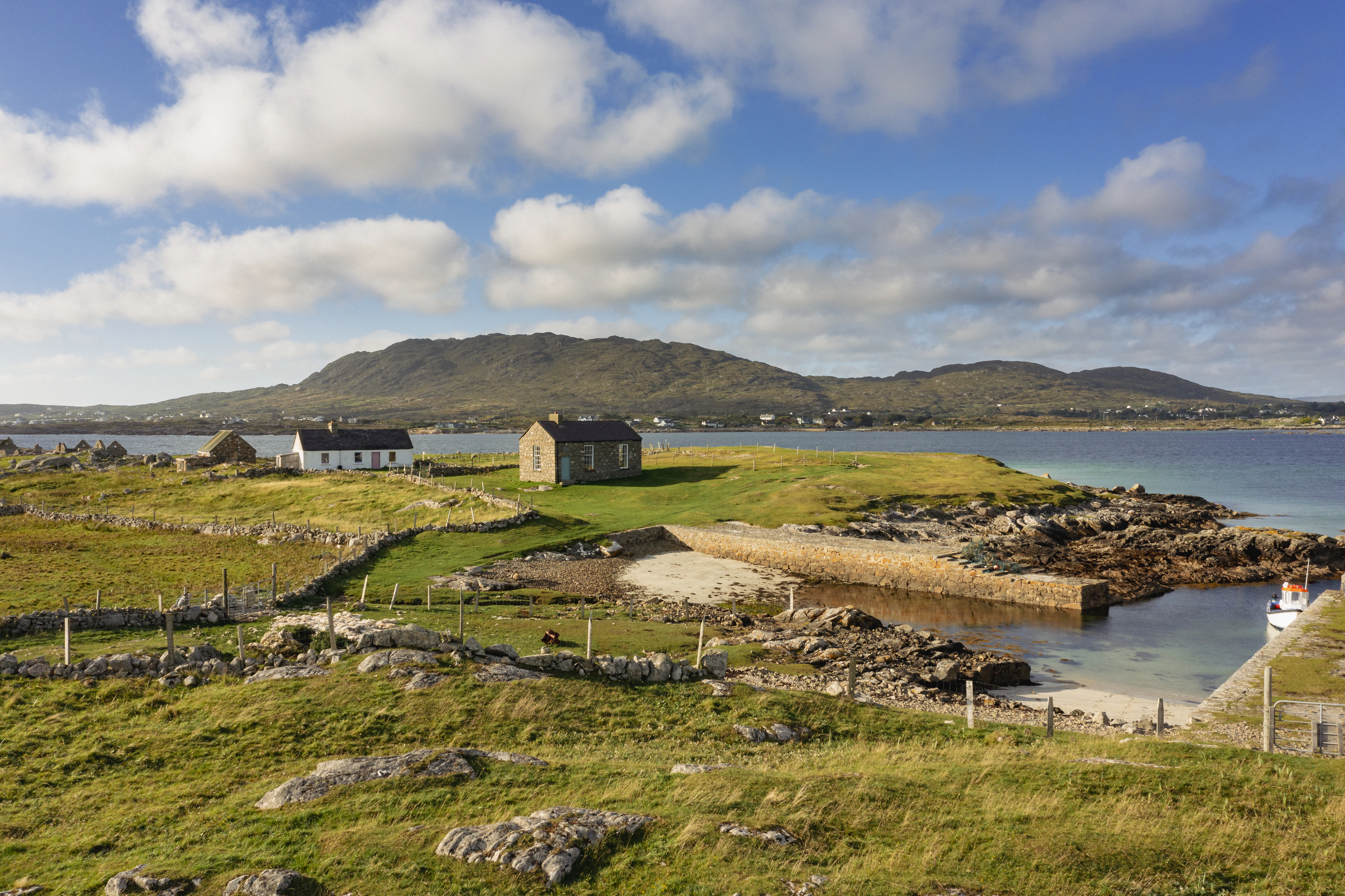 Scenic coastal landscape with buildings and a harbor.