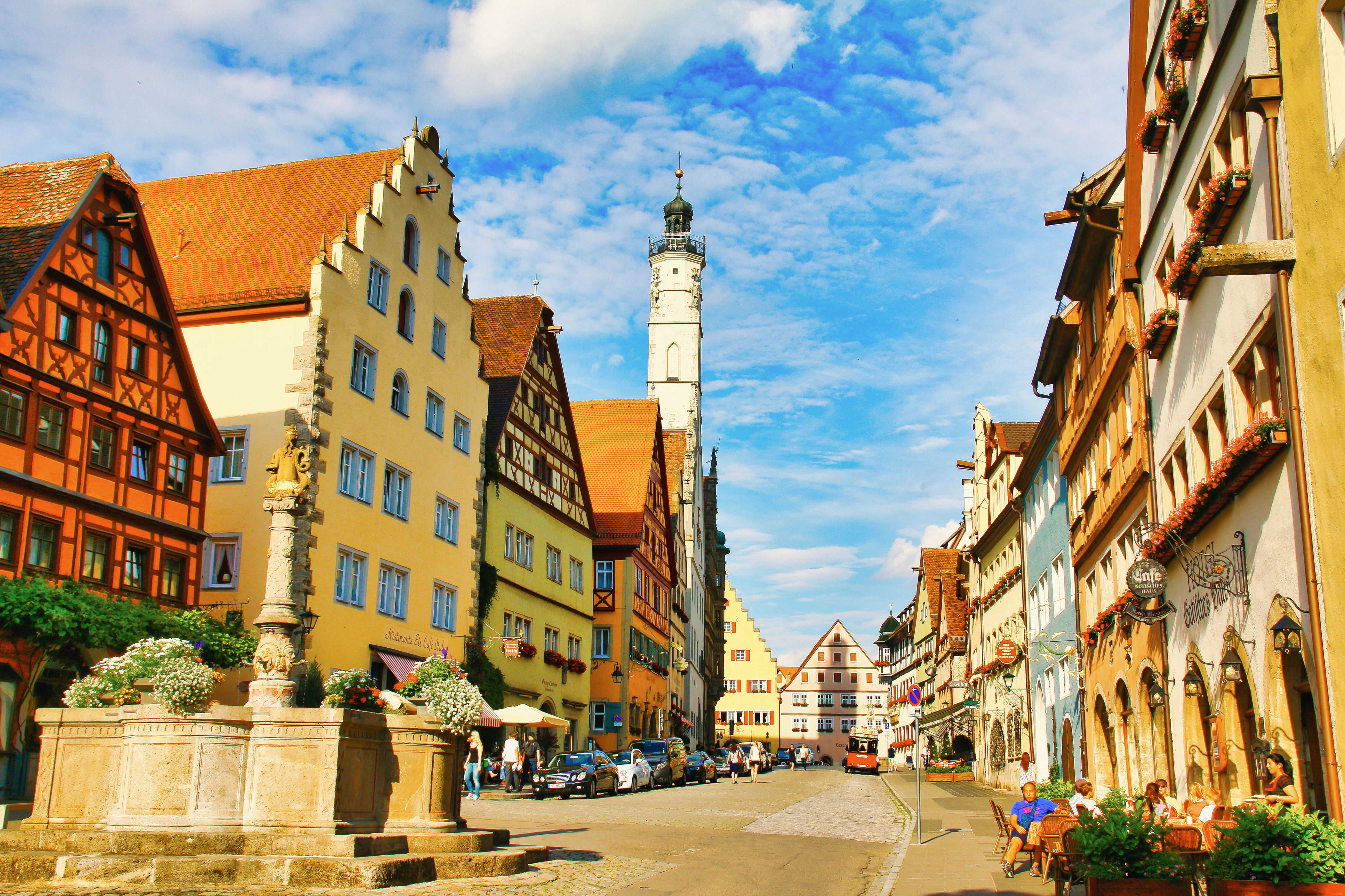 Colorful medieval buildings line a cobblestone street.