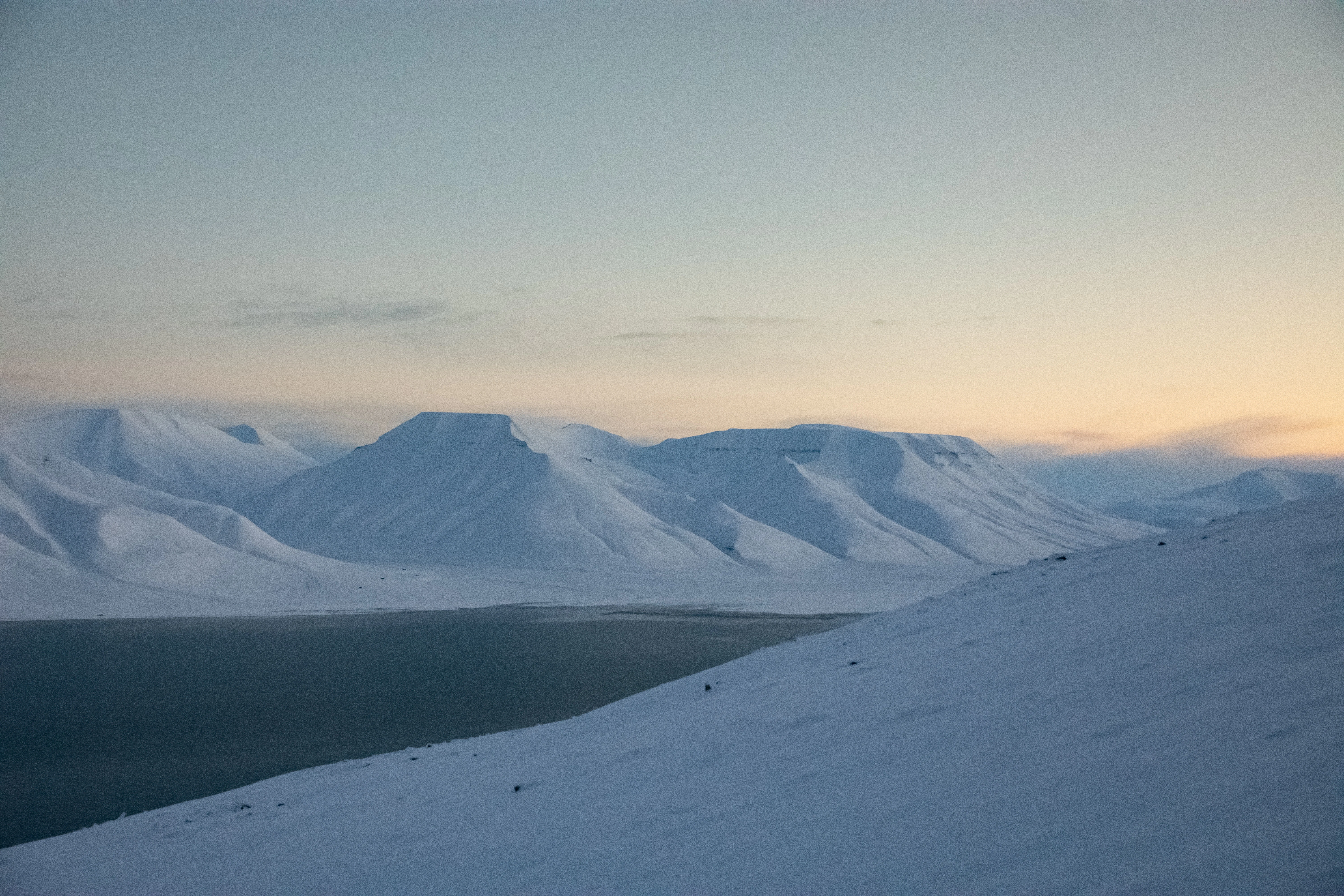 A snow covered mountain with a sky background