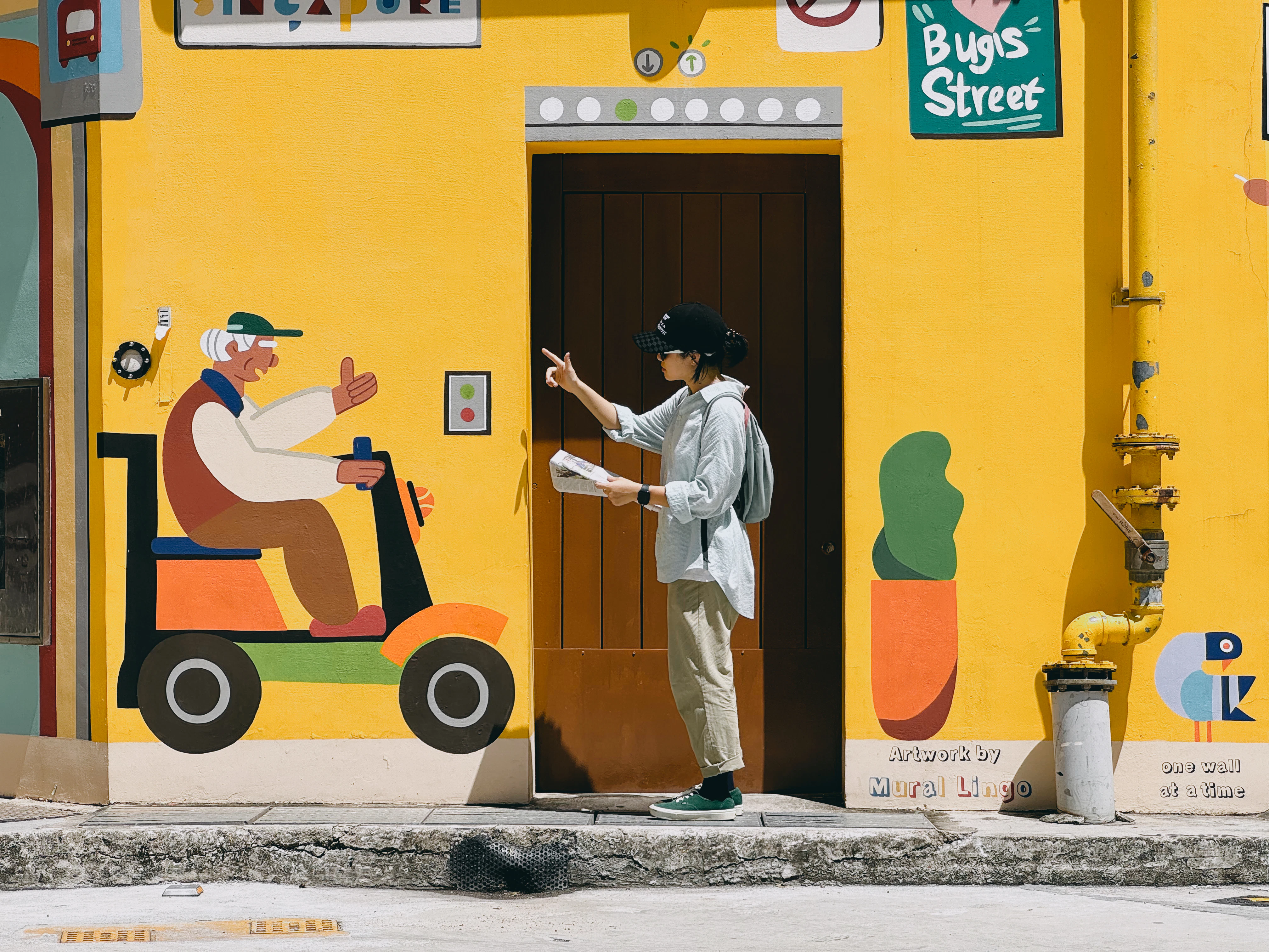 Person at door with mural of man on scooter