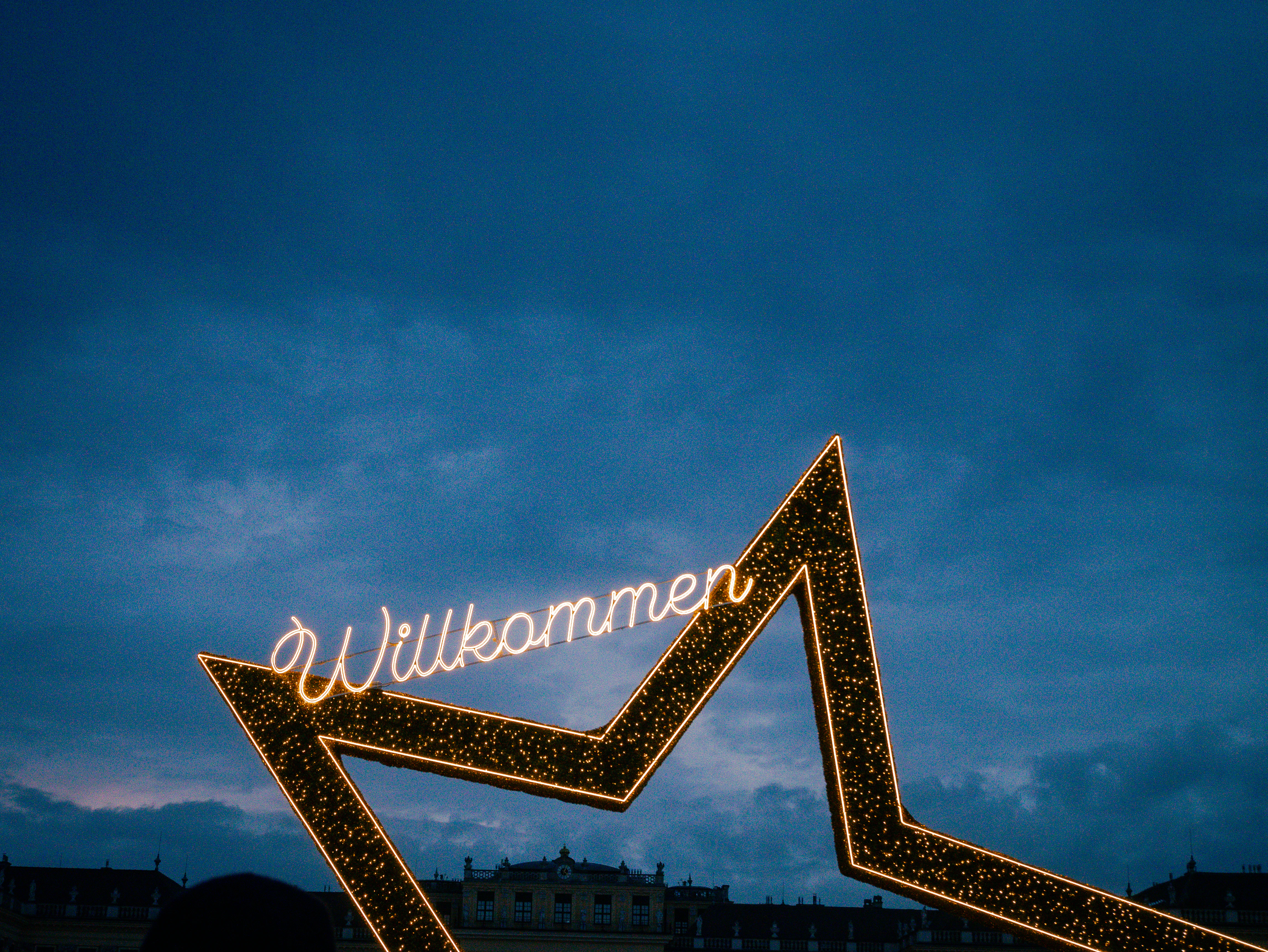 A sign that is lit up in the sky