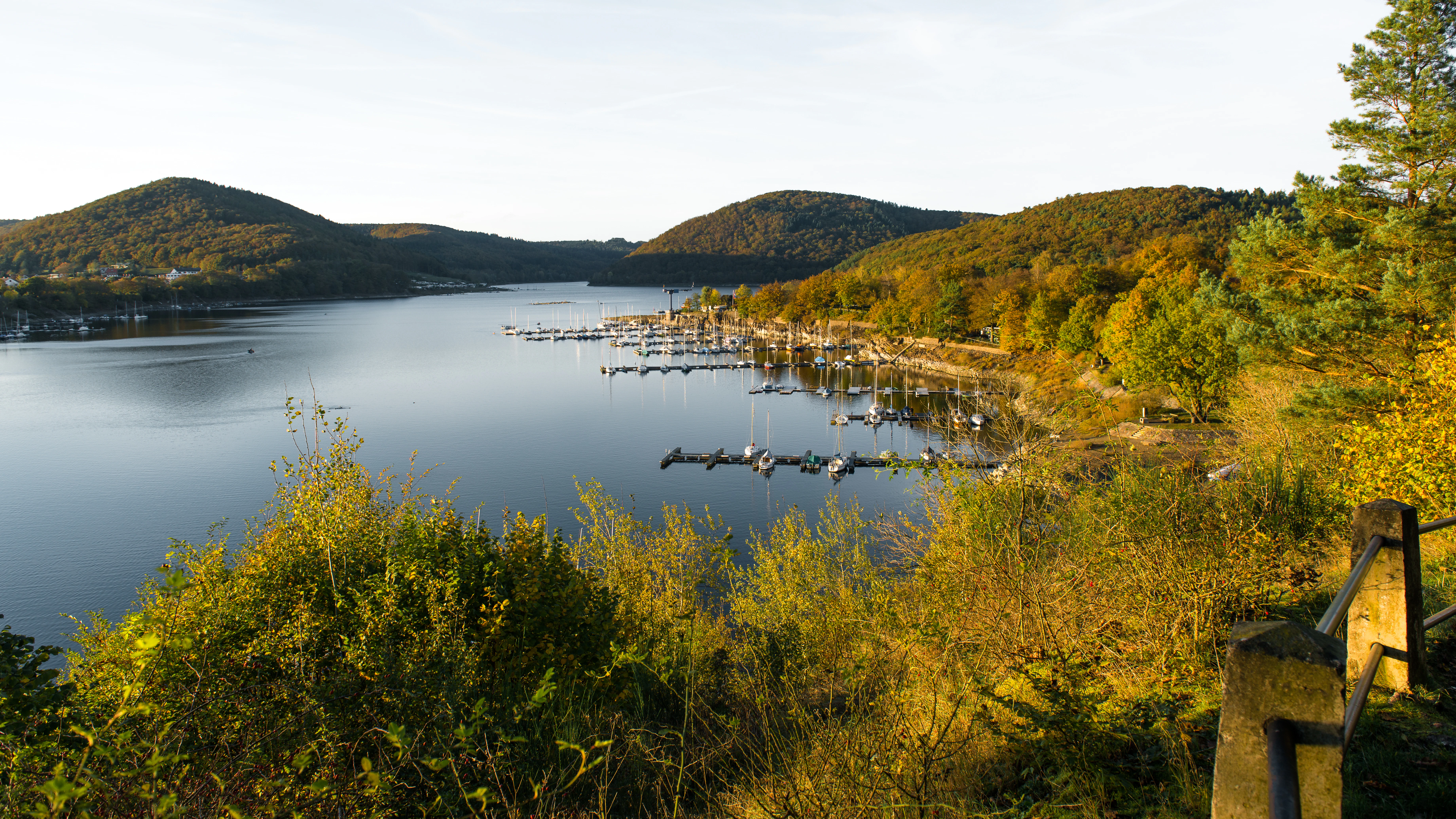 A serene lake surrounded by wooded hills.