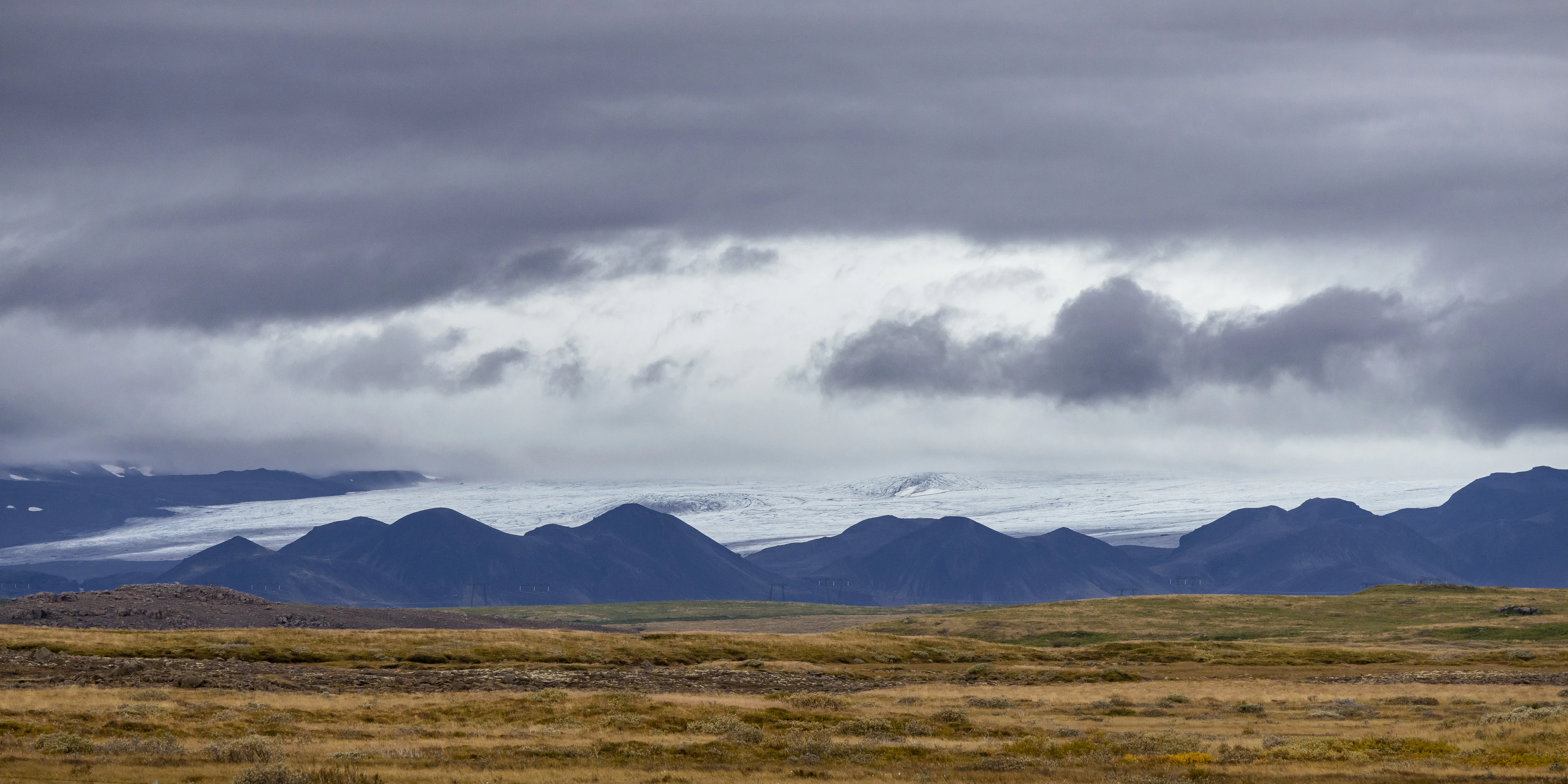 a landscape with mountains in the back