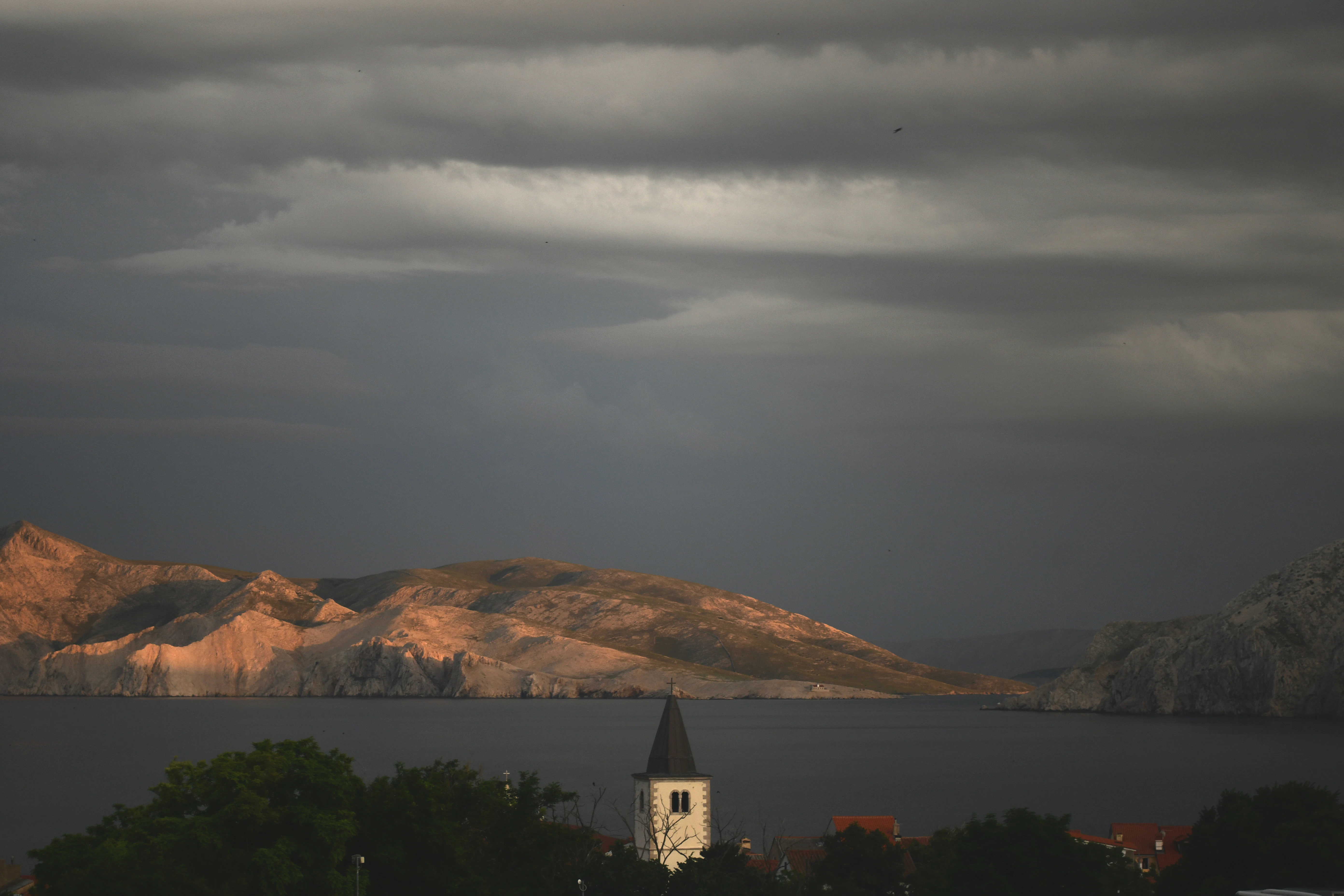 A view of a lake with a church in the foreground