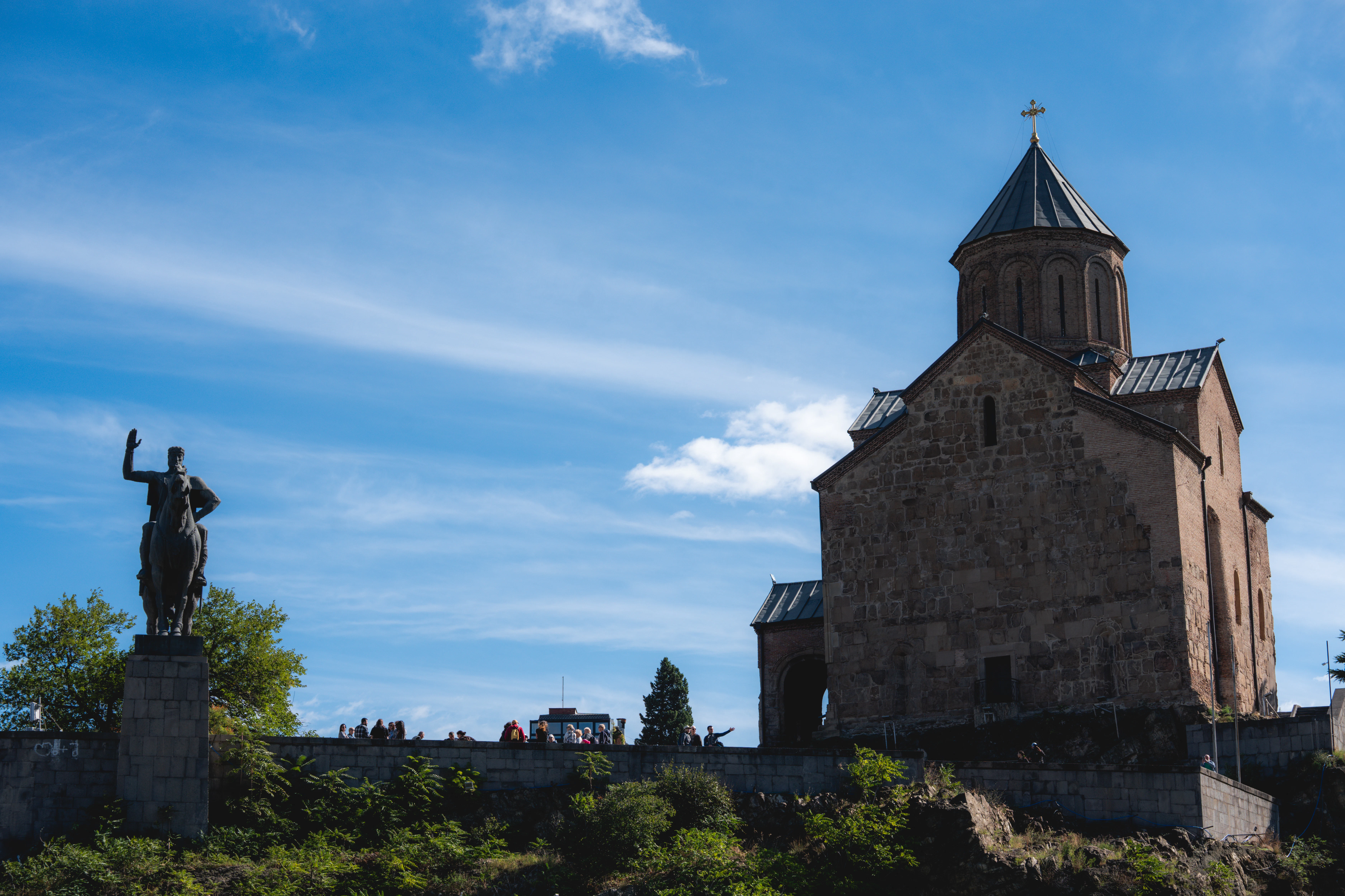Stone church and statue on a hill