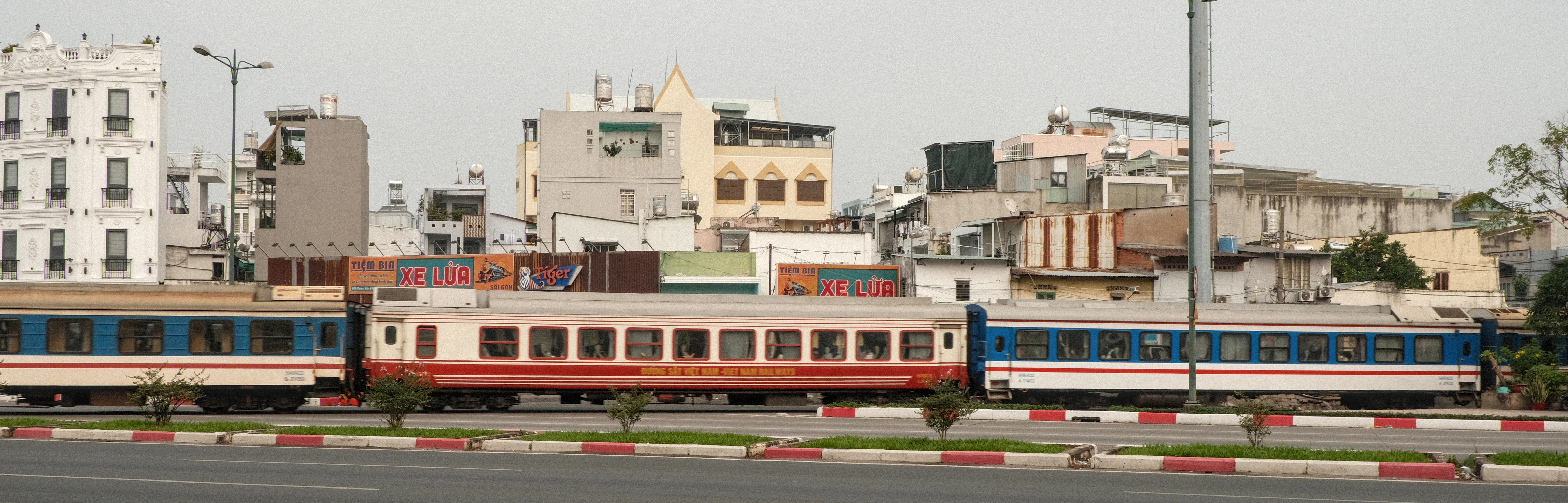 Trains parked in front of city buildings
