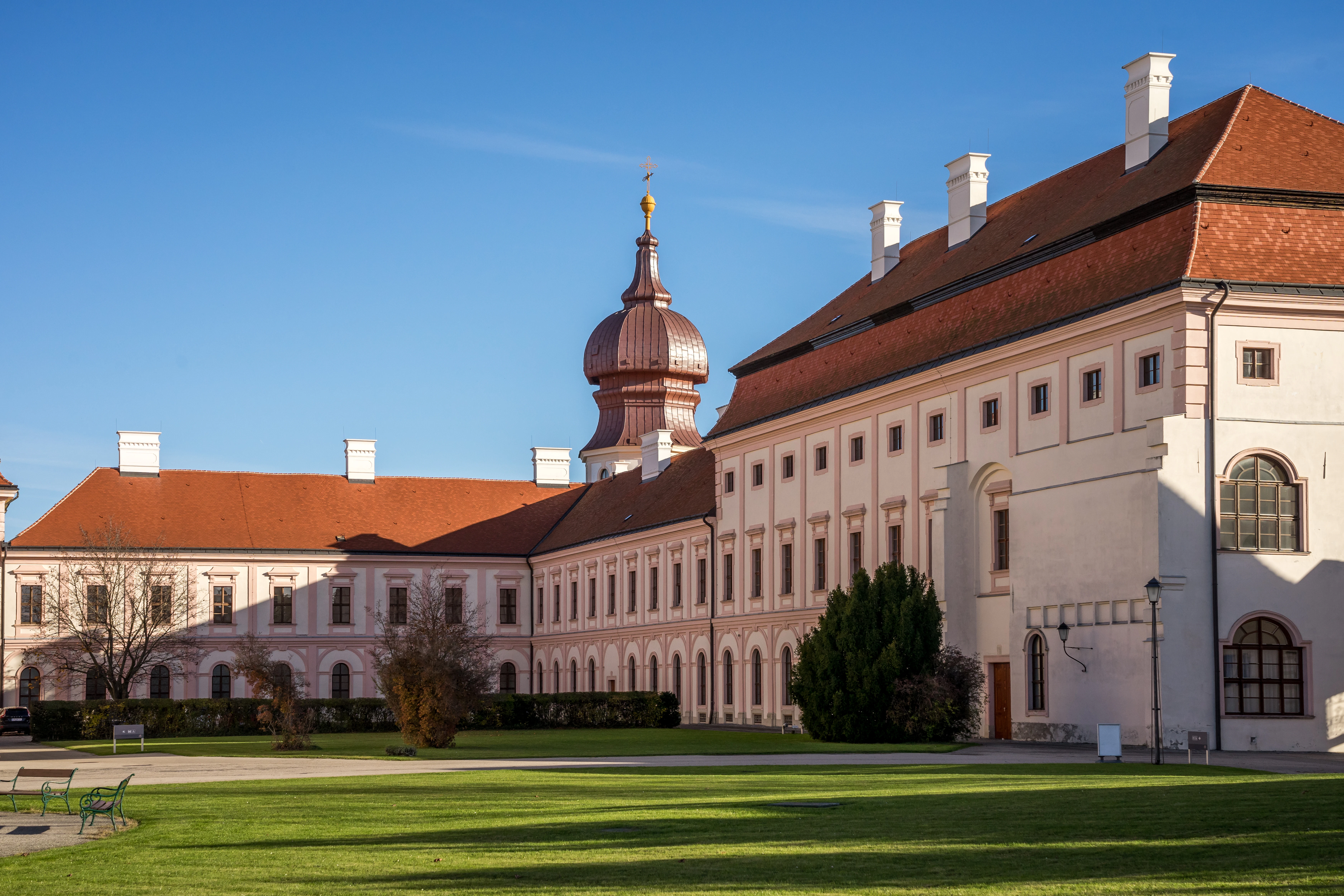 a large building with a lawn in front of it