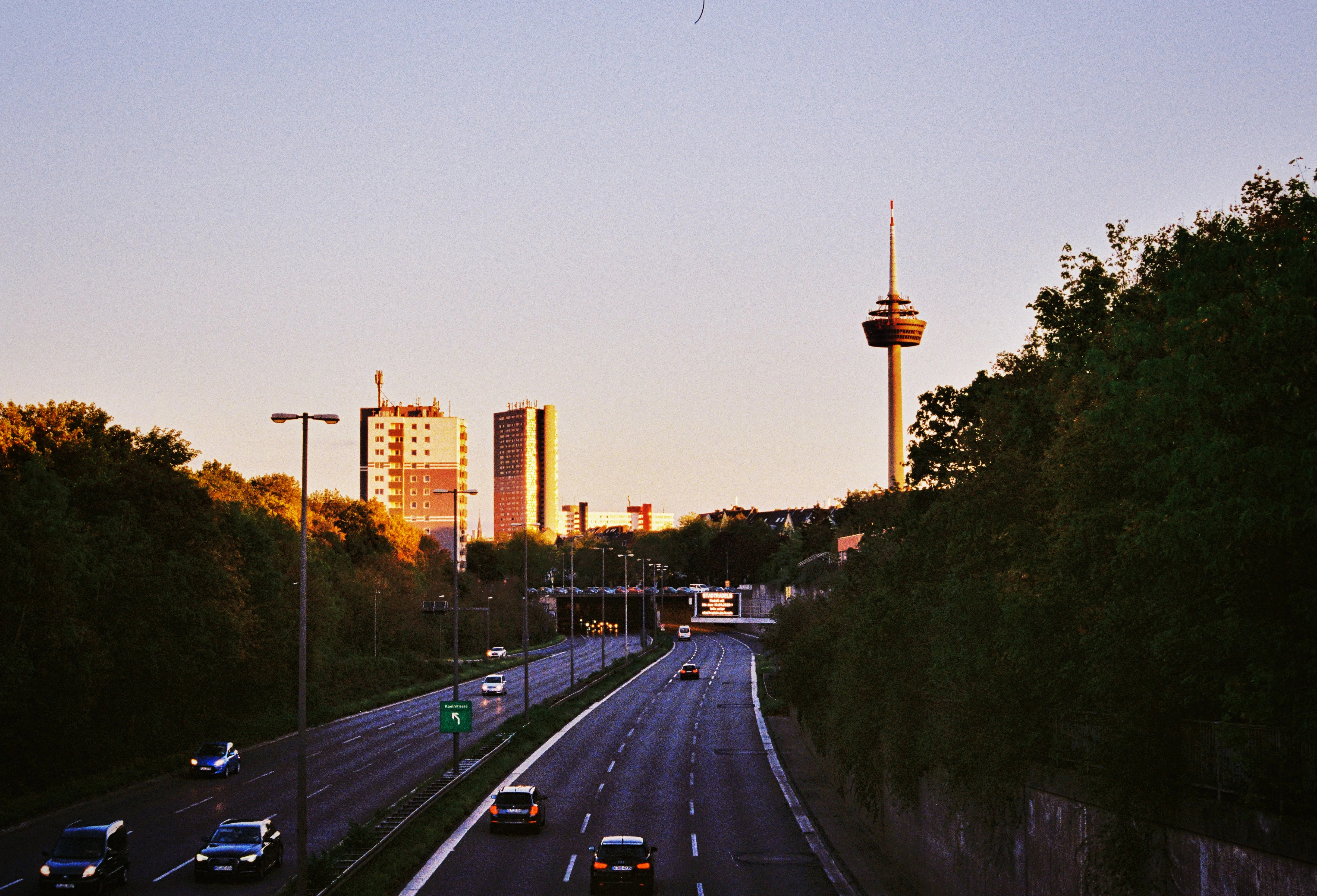 A highway leads to a city's distant skyline.