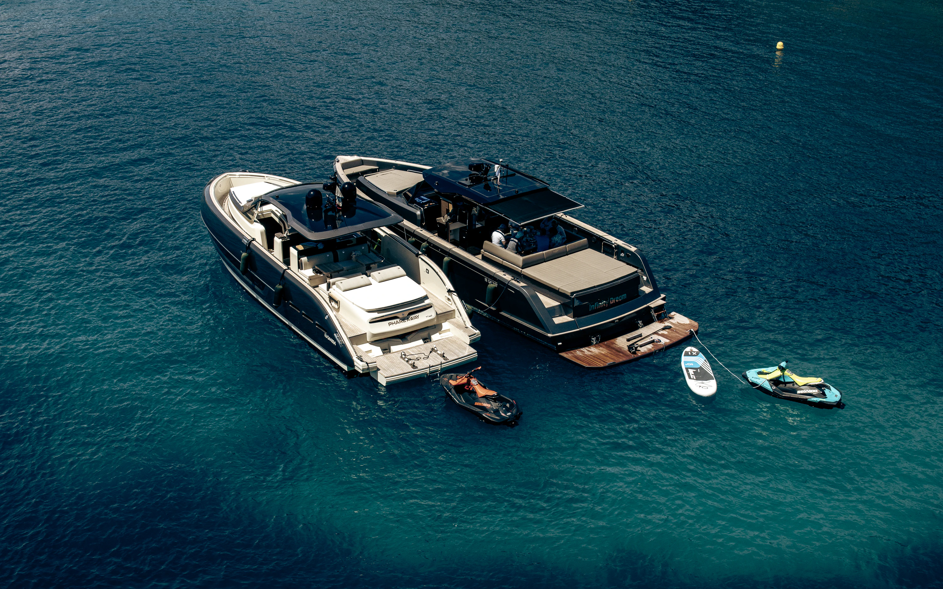 A couple of boats floating on top of a body of water