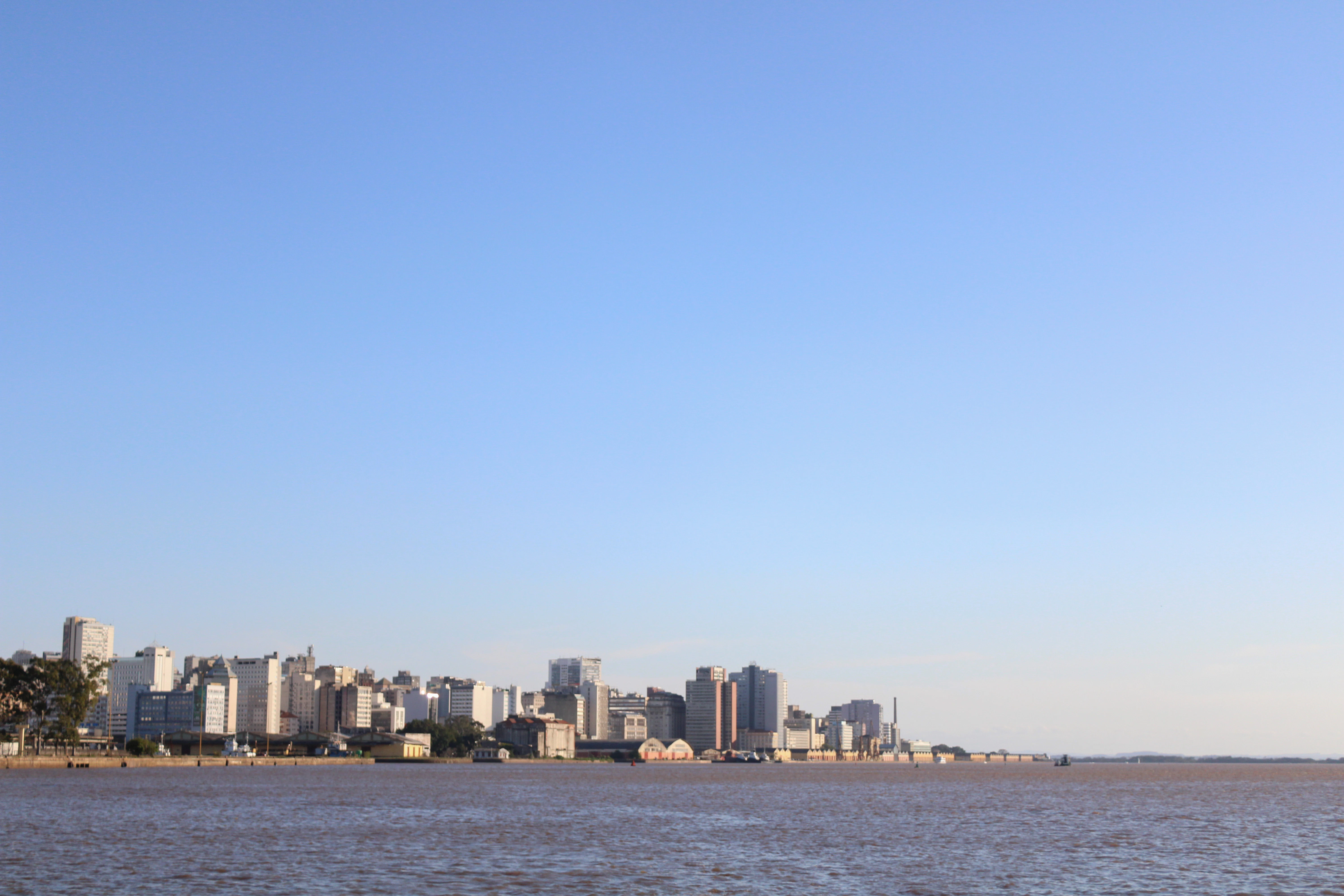 a large body of water with a city in the background