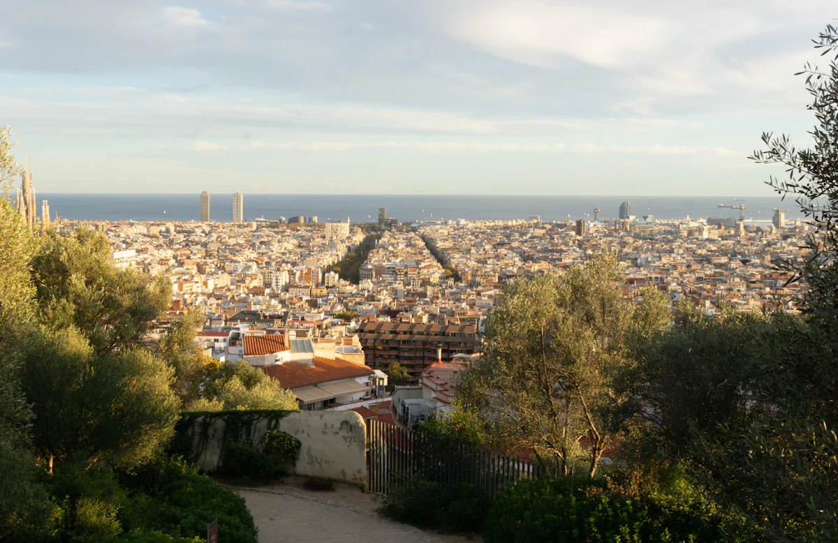 Panoramic view of a sprawling city with ocean backdrop.