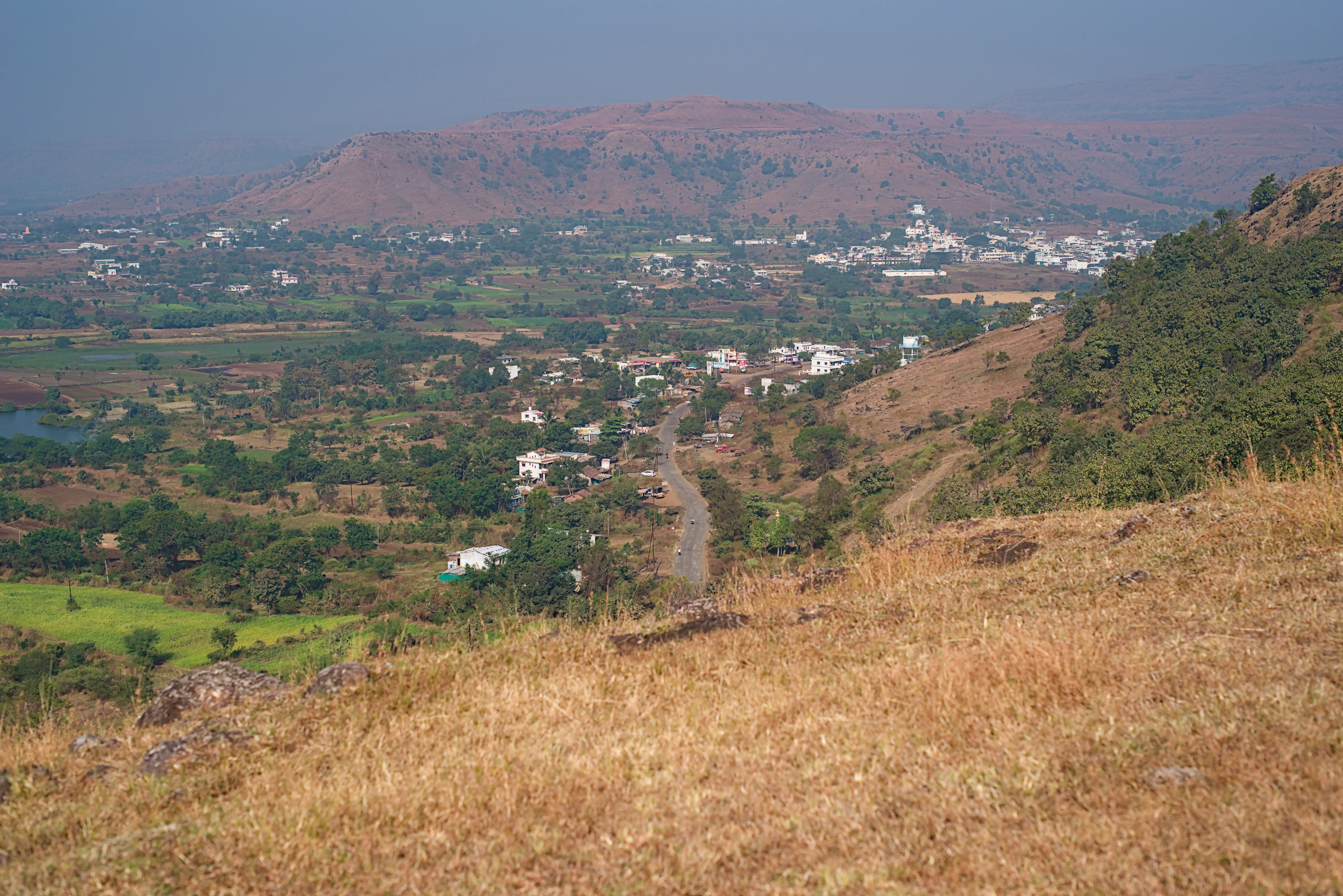 Hilly landscape with a small town in the distance.