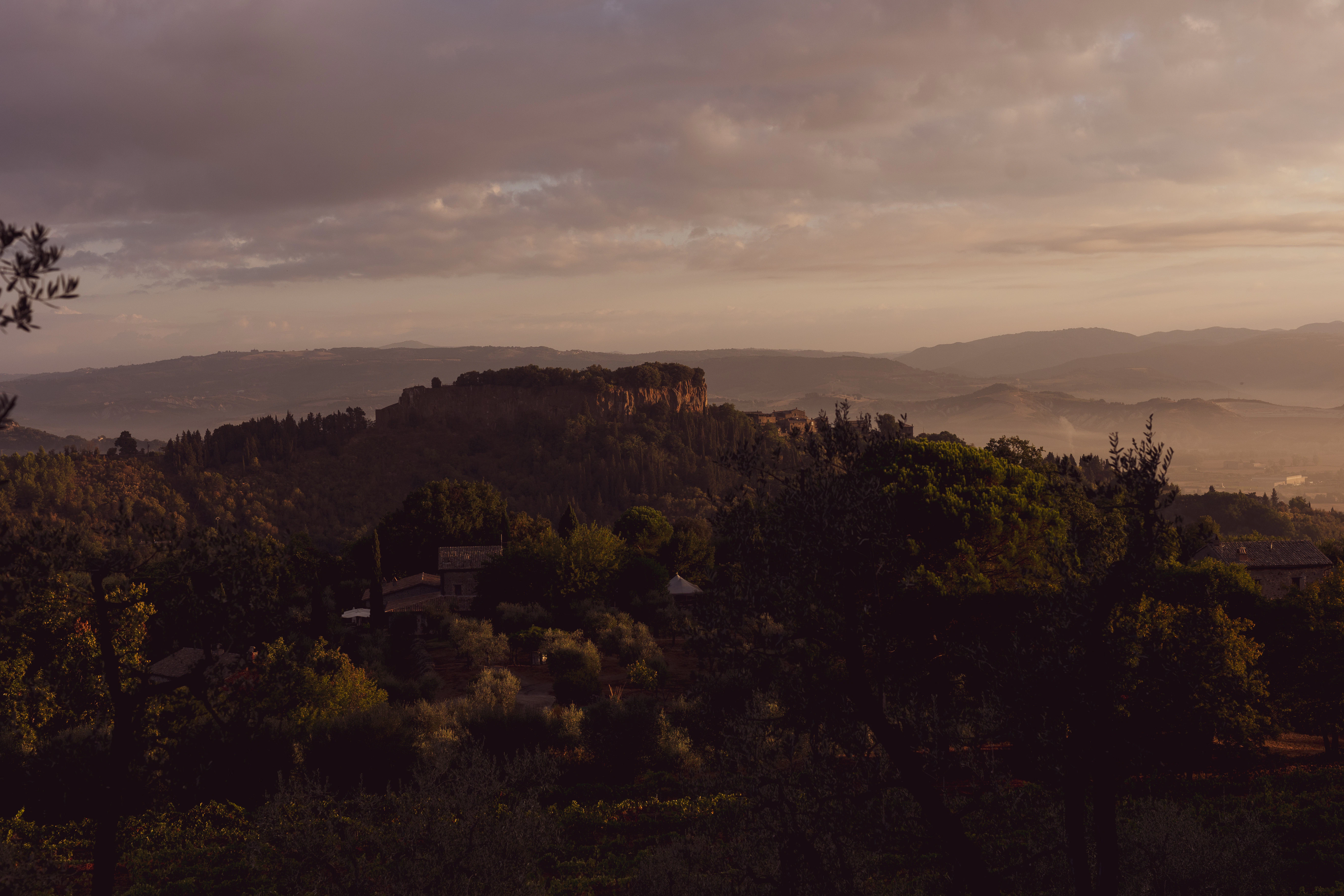 a view of a hill with a castle in the distance