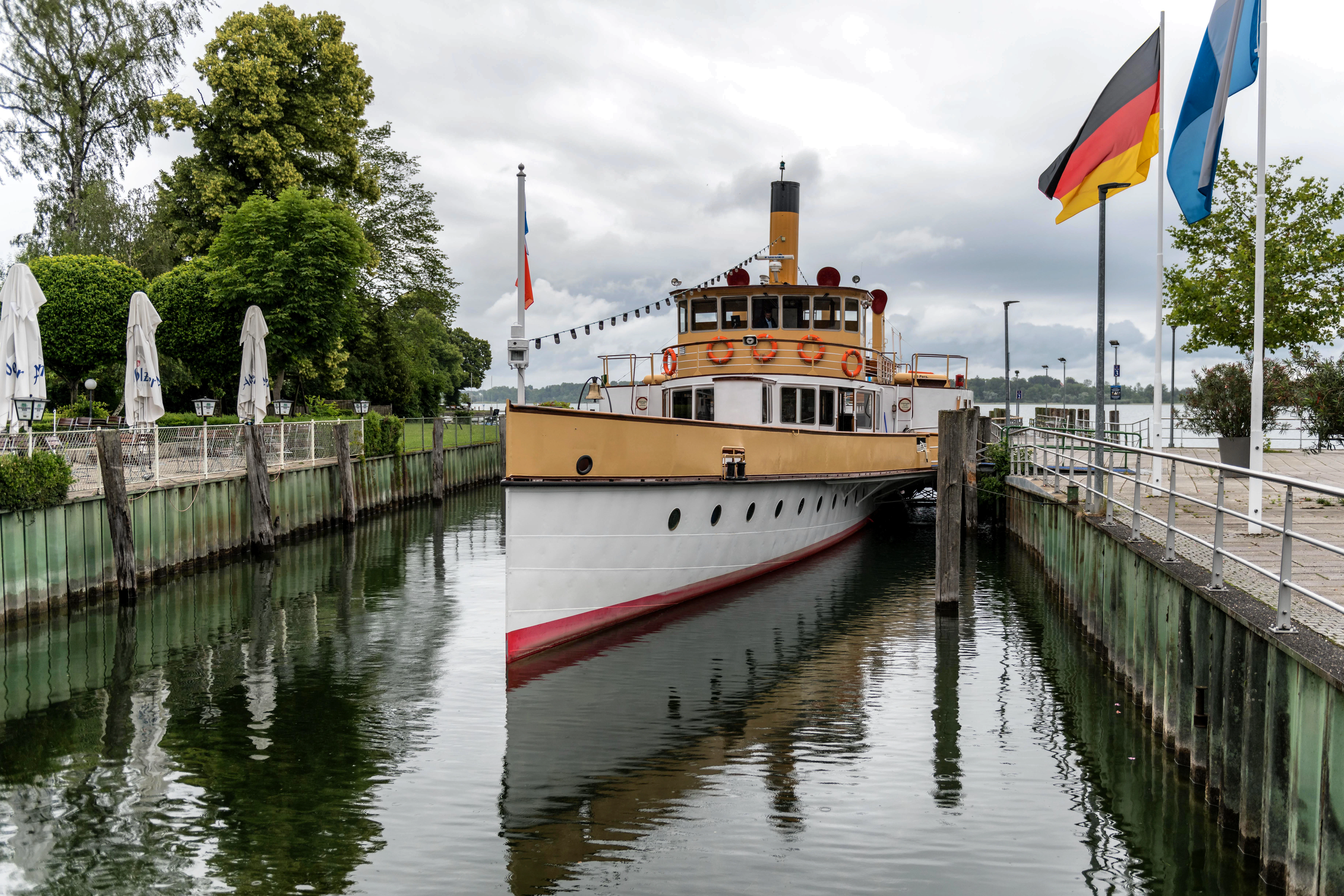 Steamboat entering a canal with flags flying