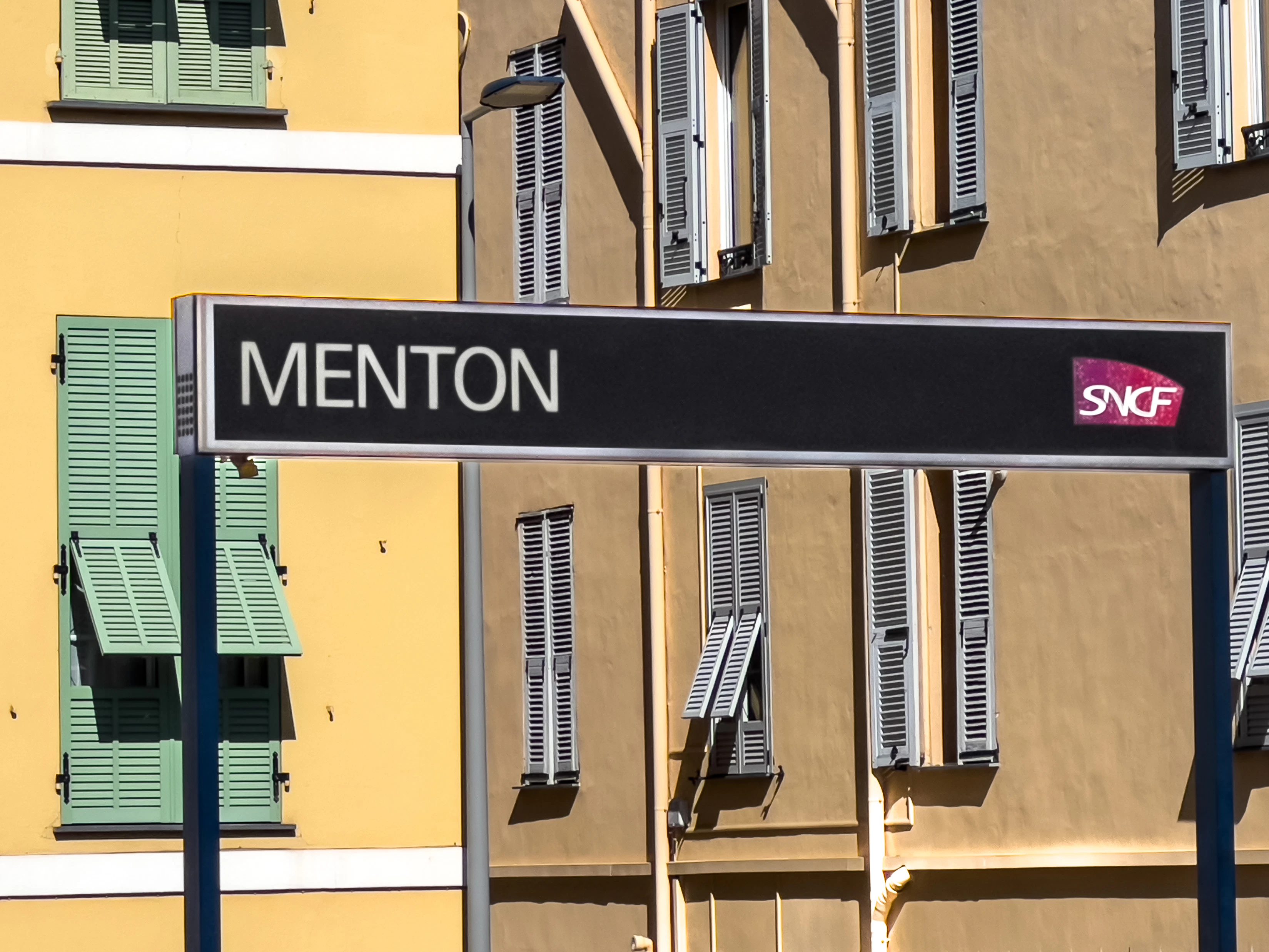 A street sign in front of a multi - colored building