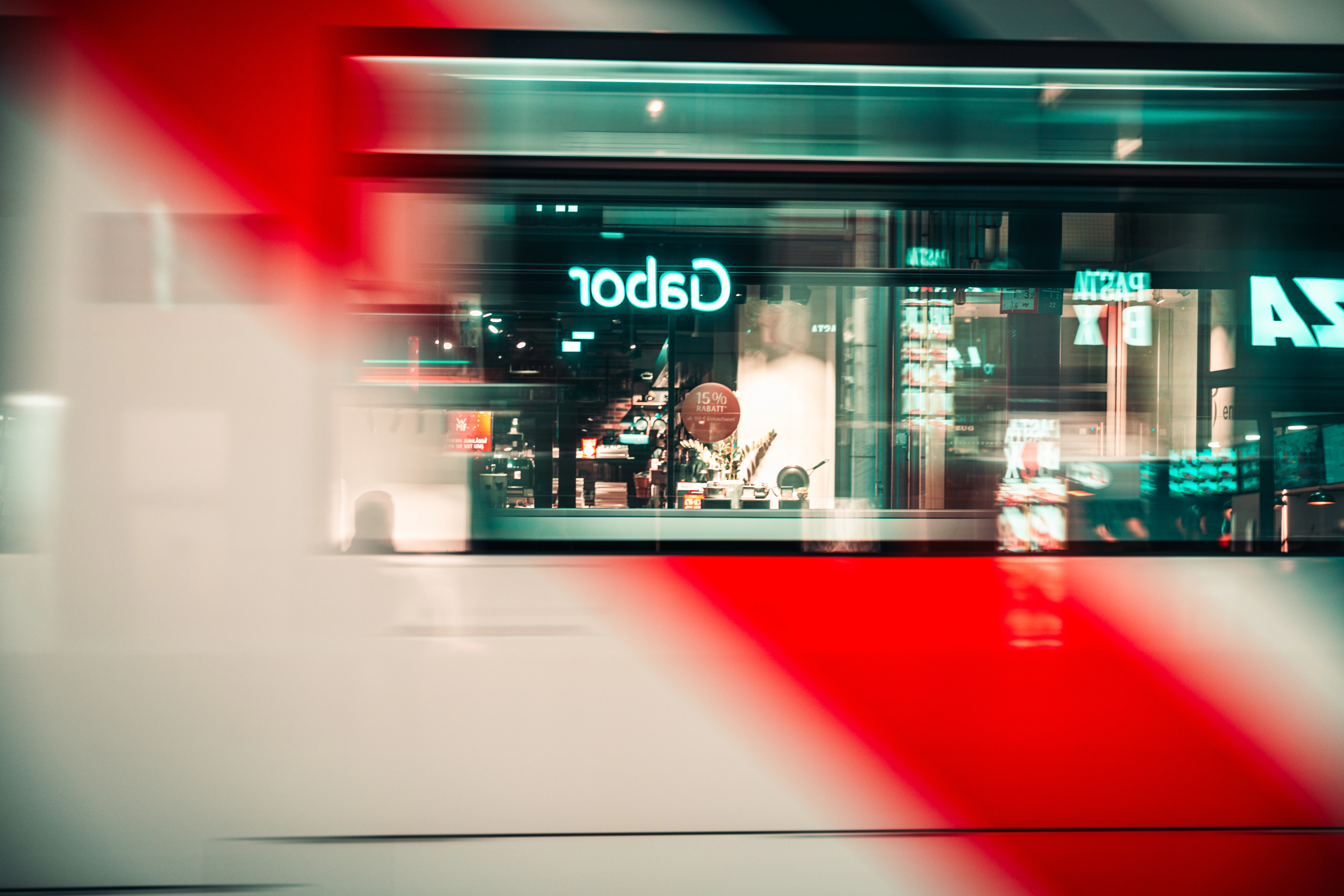 Blurred view of a storefront with red stripes