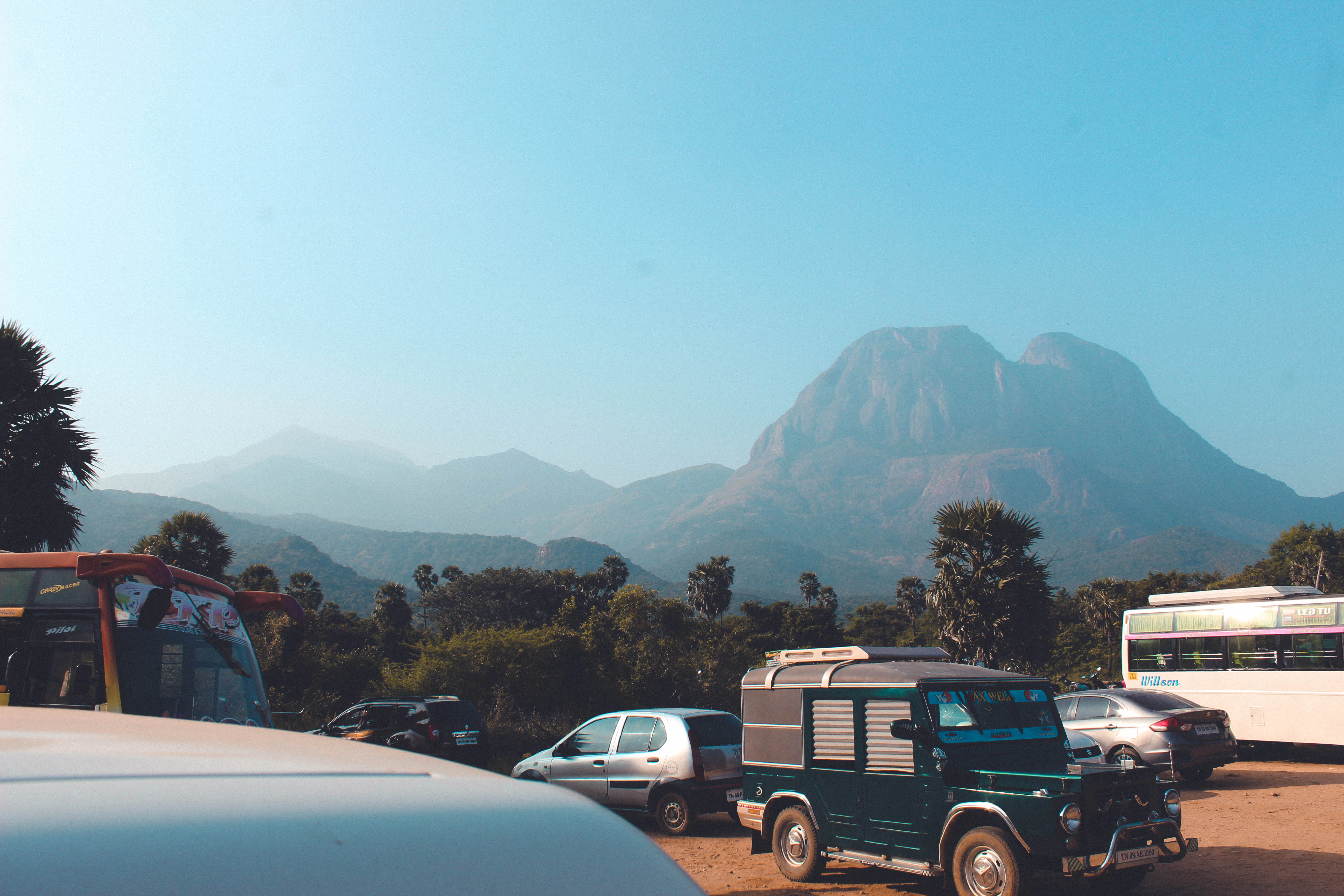 a truck parked in a parking lot next to a mountain