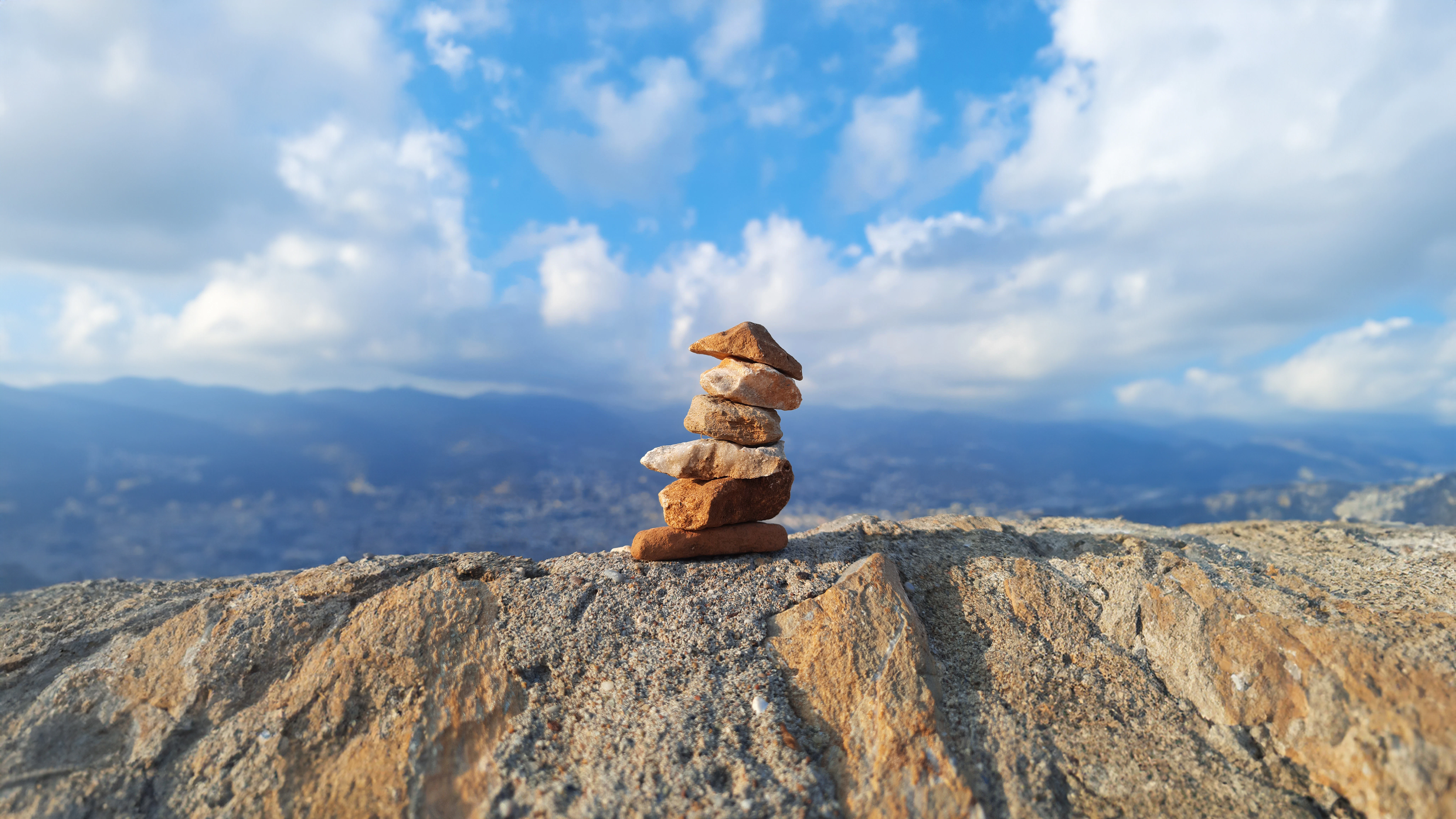 a stack of rocks sitting on top of a mountain