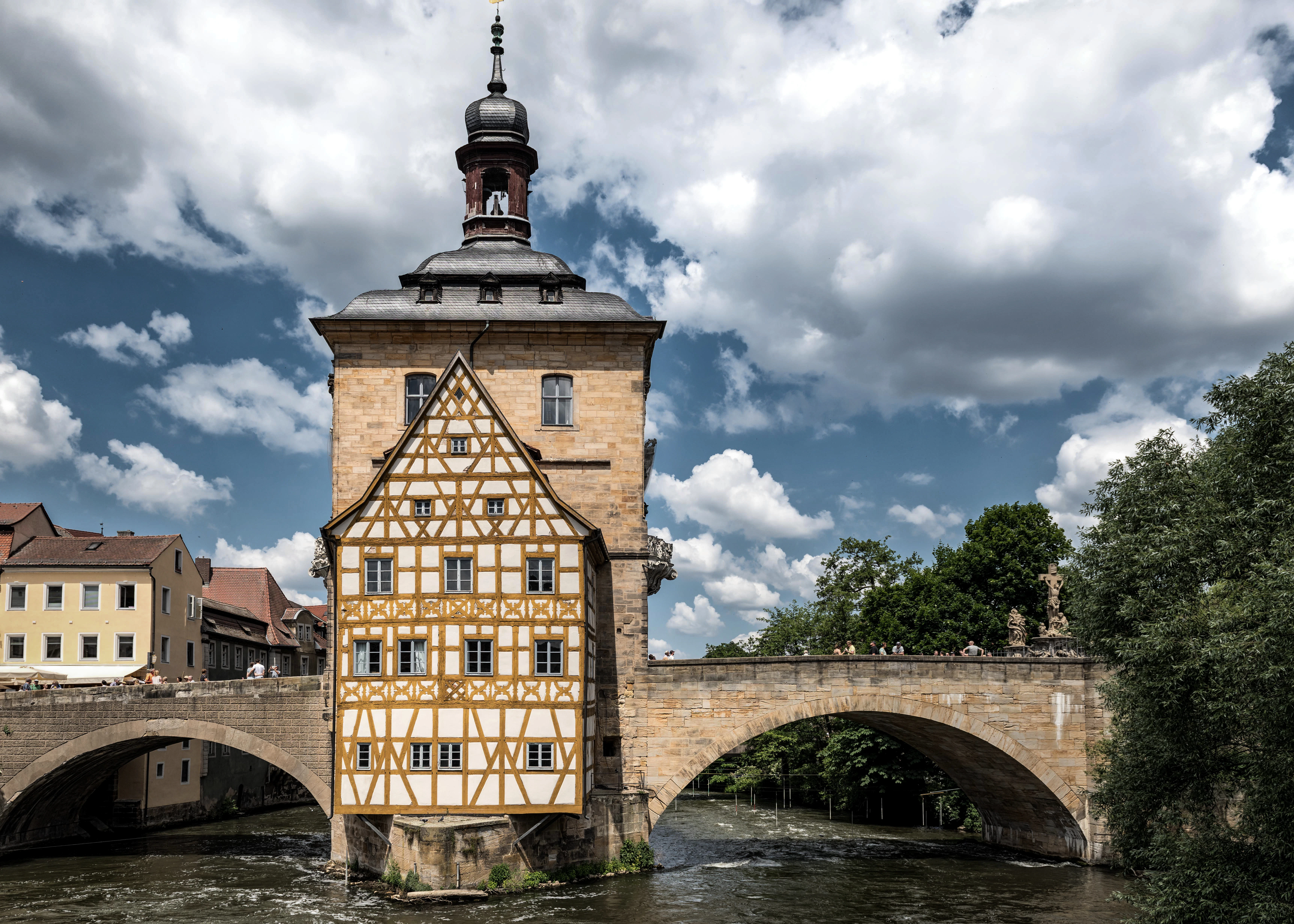 A building with a tower and a bridge in the background