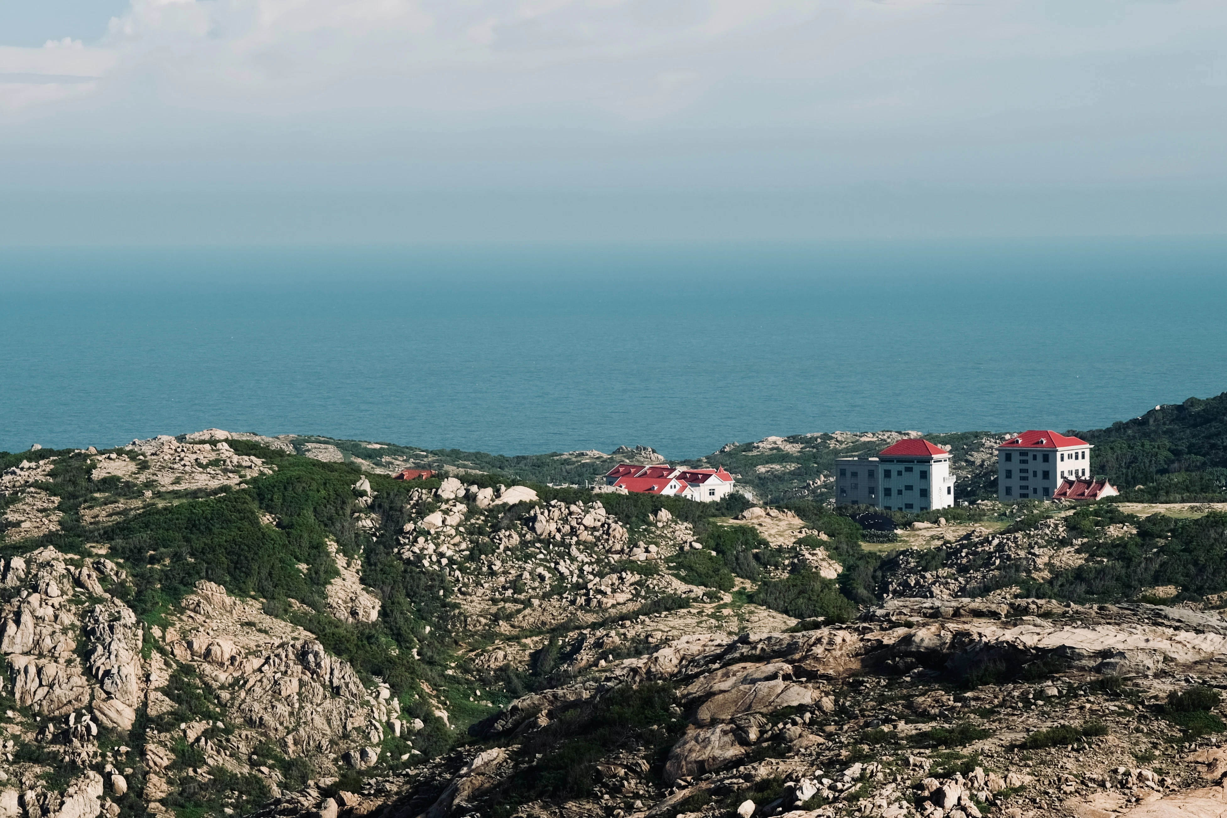 Buildings on a rocky coast overlooking the ocean