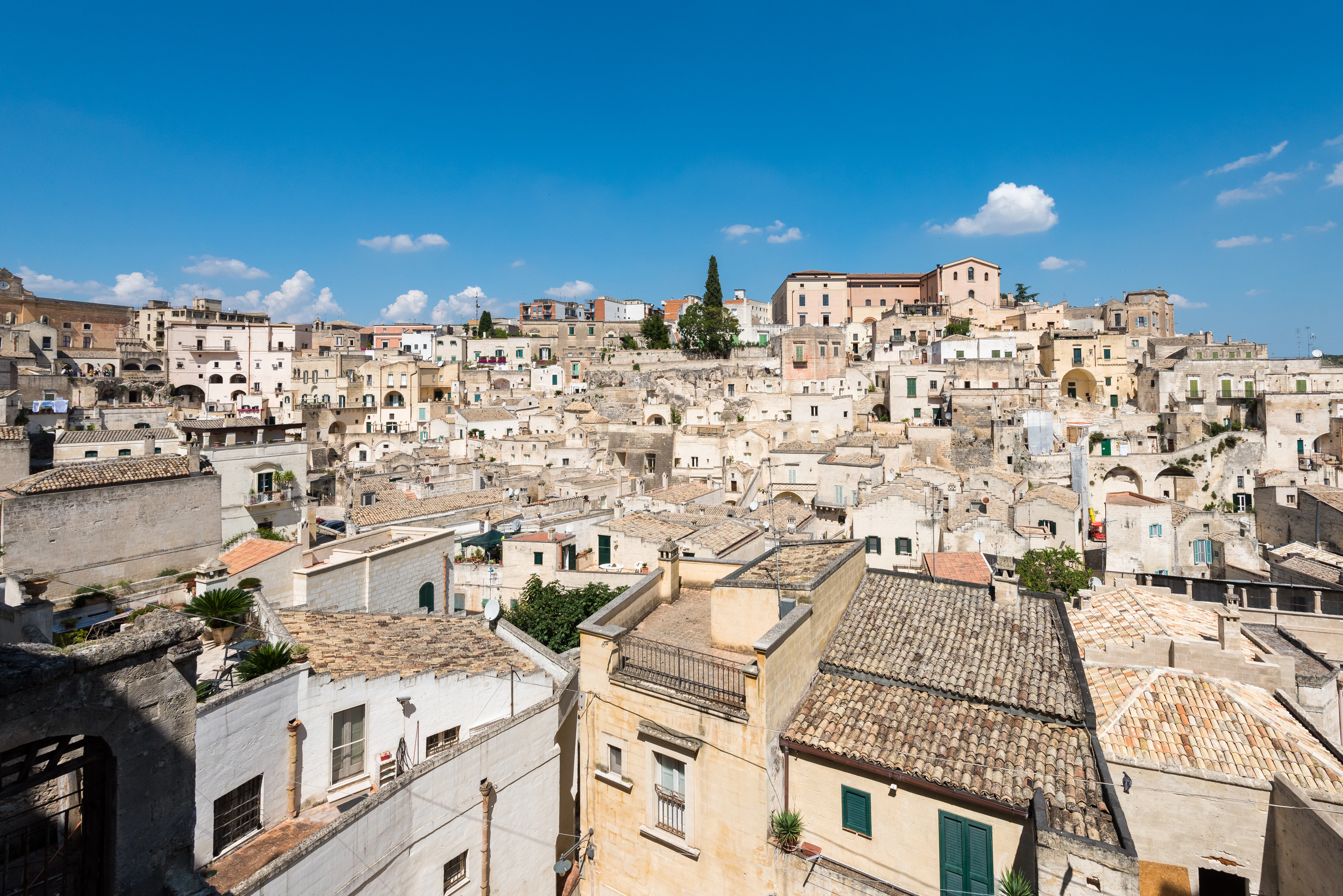 White buildings sit under a bright blue sky.
