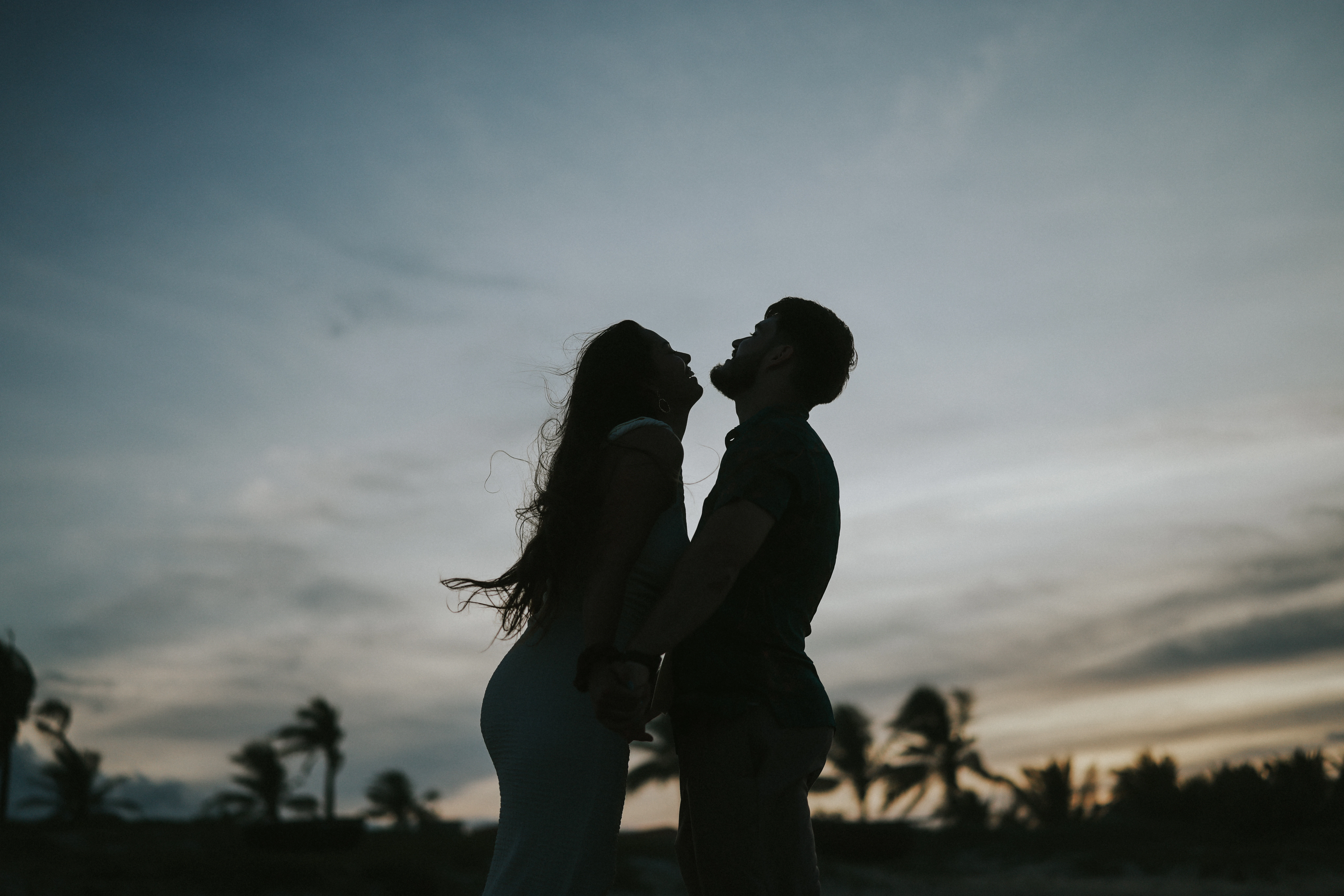 Couple embracing on a beach at sunset