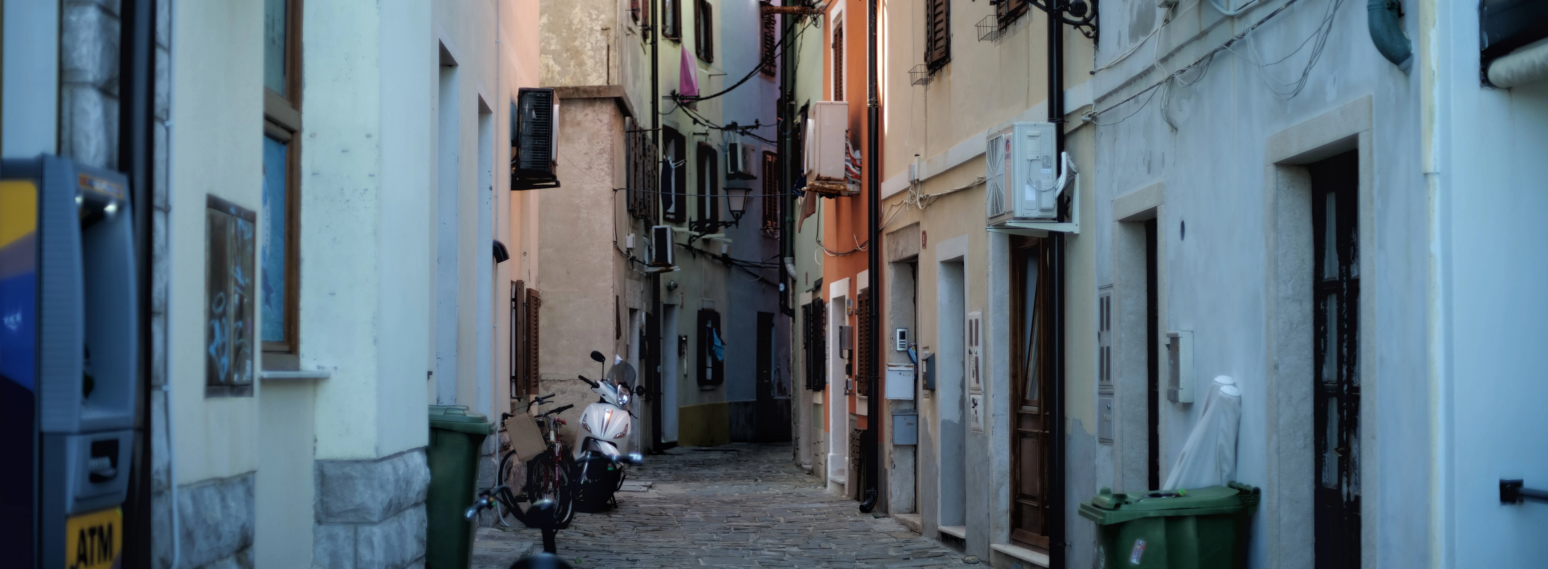 a narrow alleyway with motorcycles