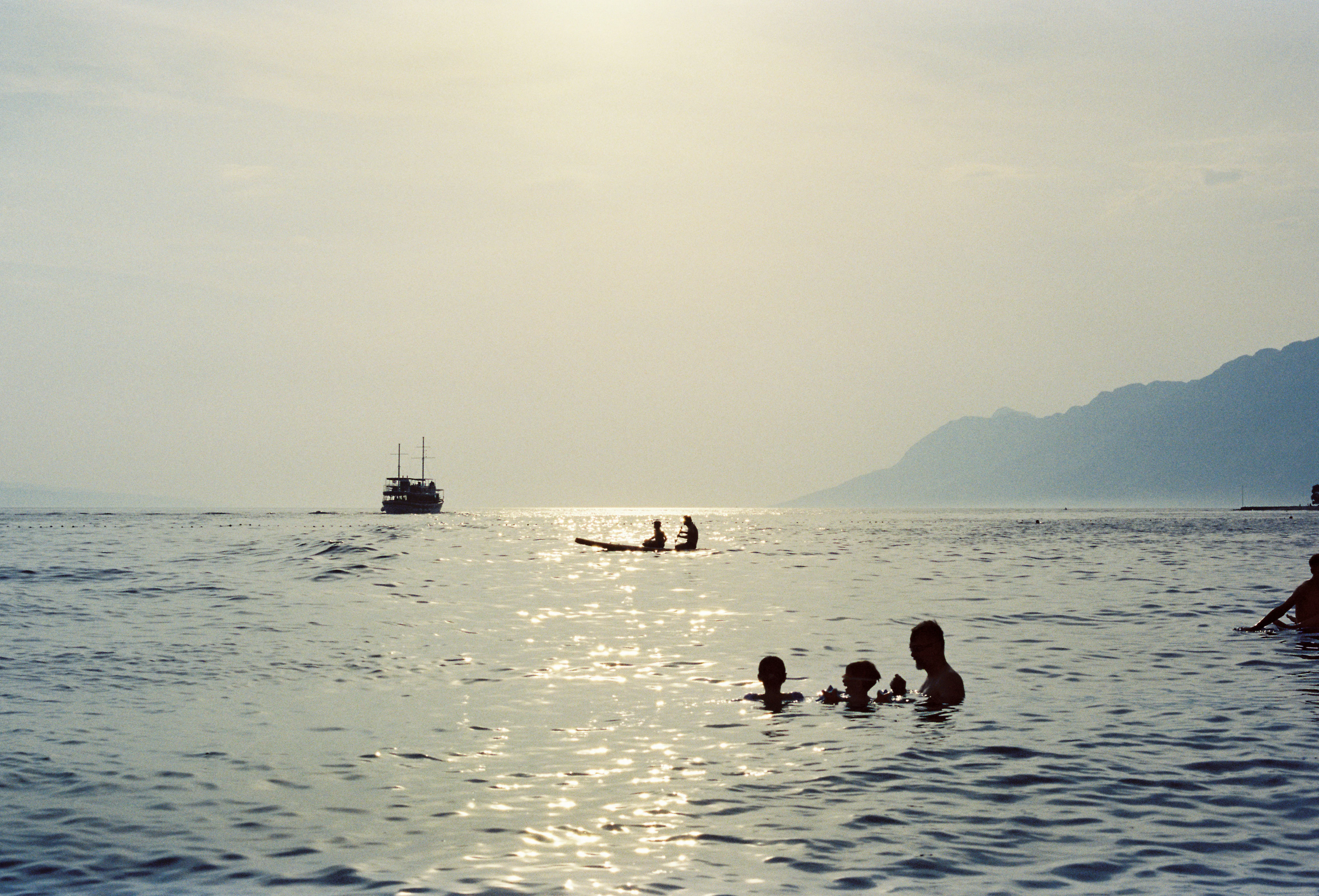 A group of people swimming in the ocean