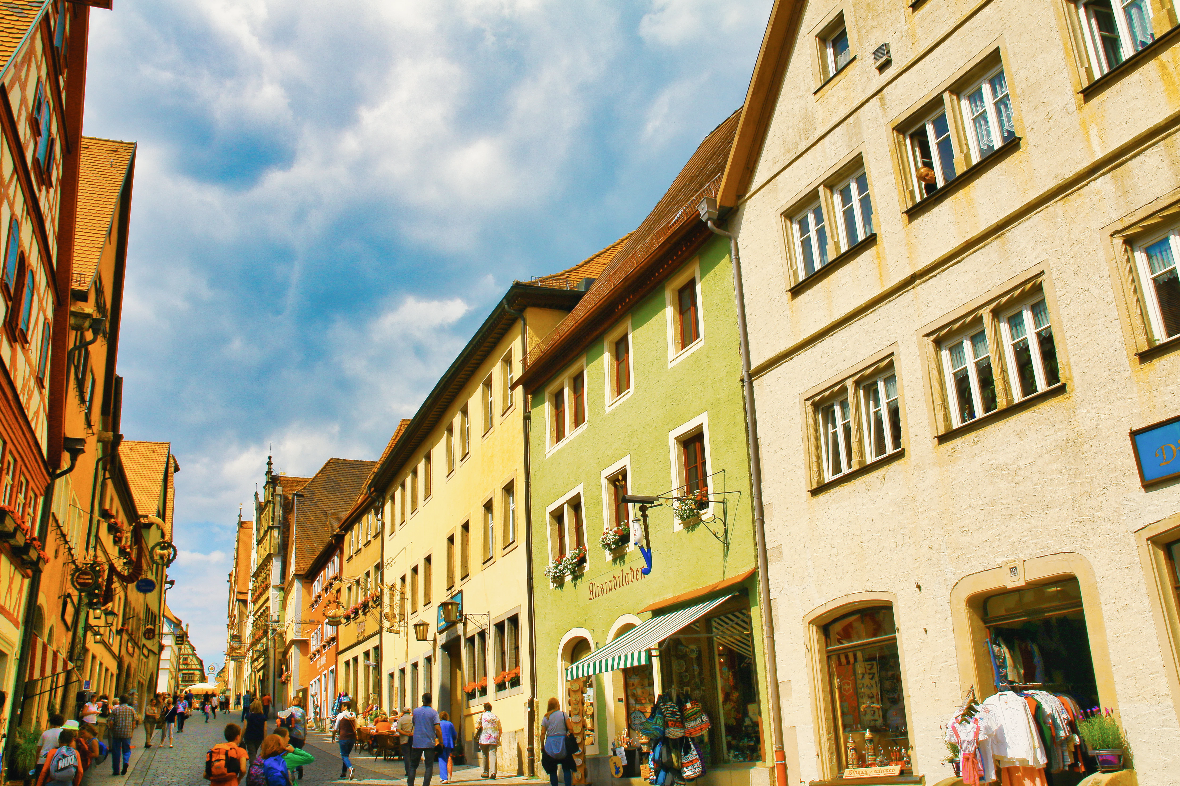 Colorful buildings line a european street with people.