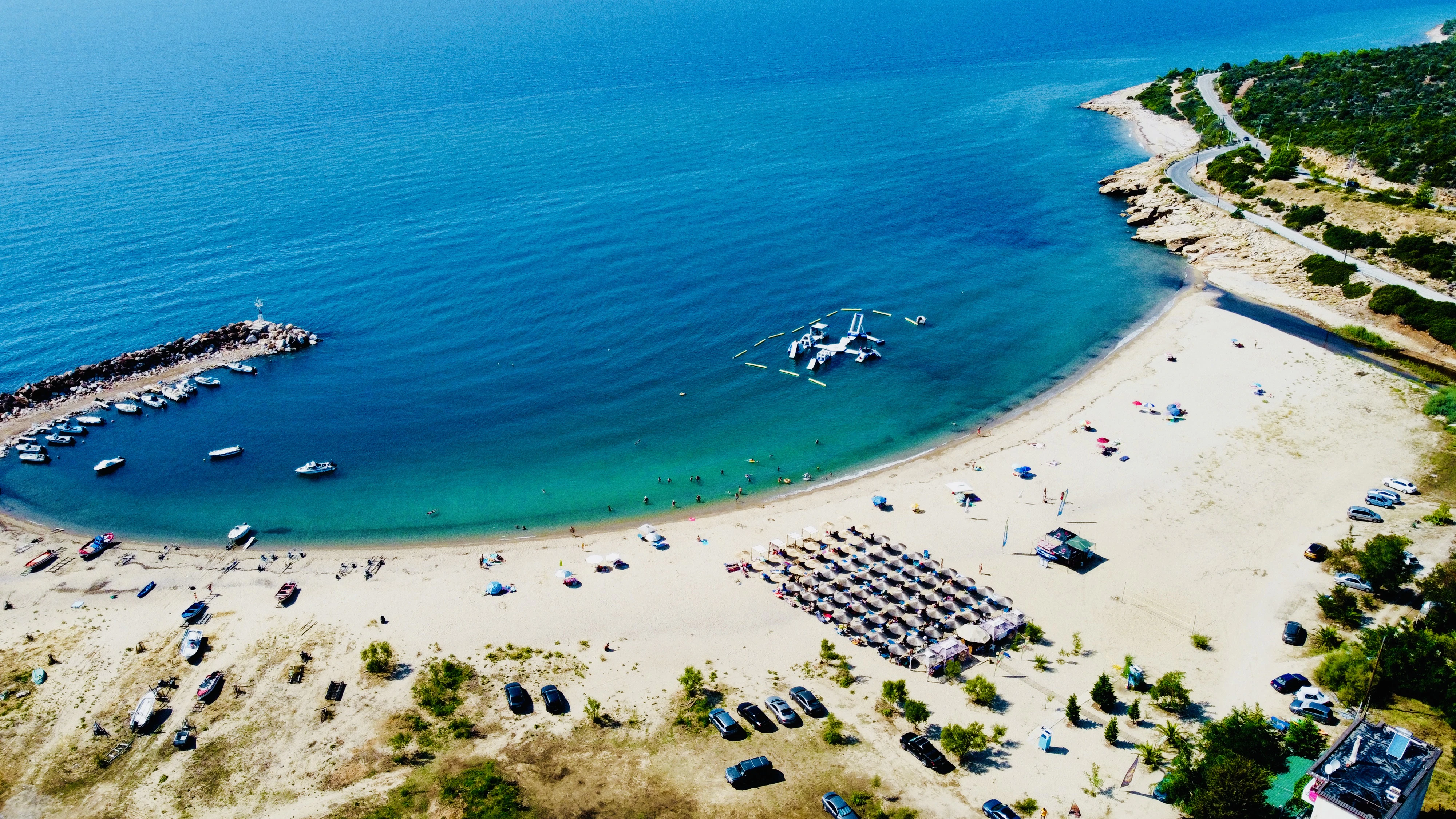 a beach with boats and people