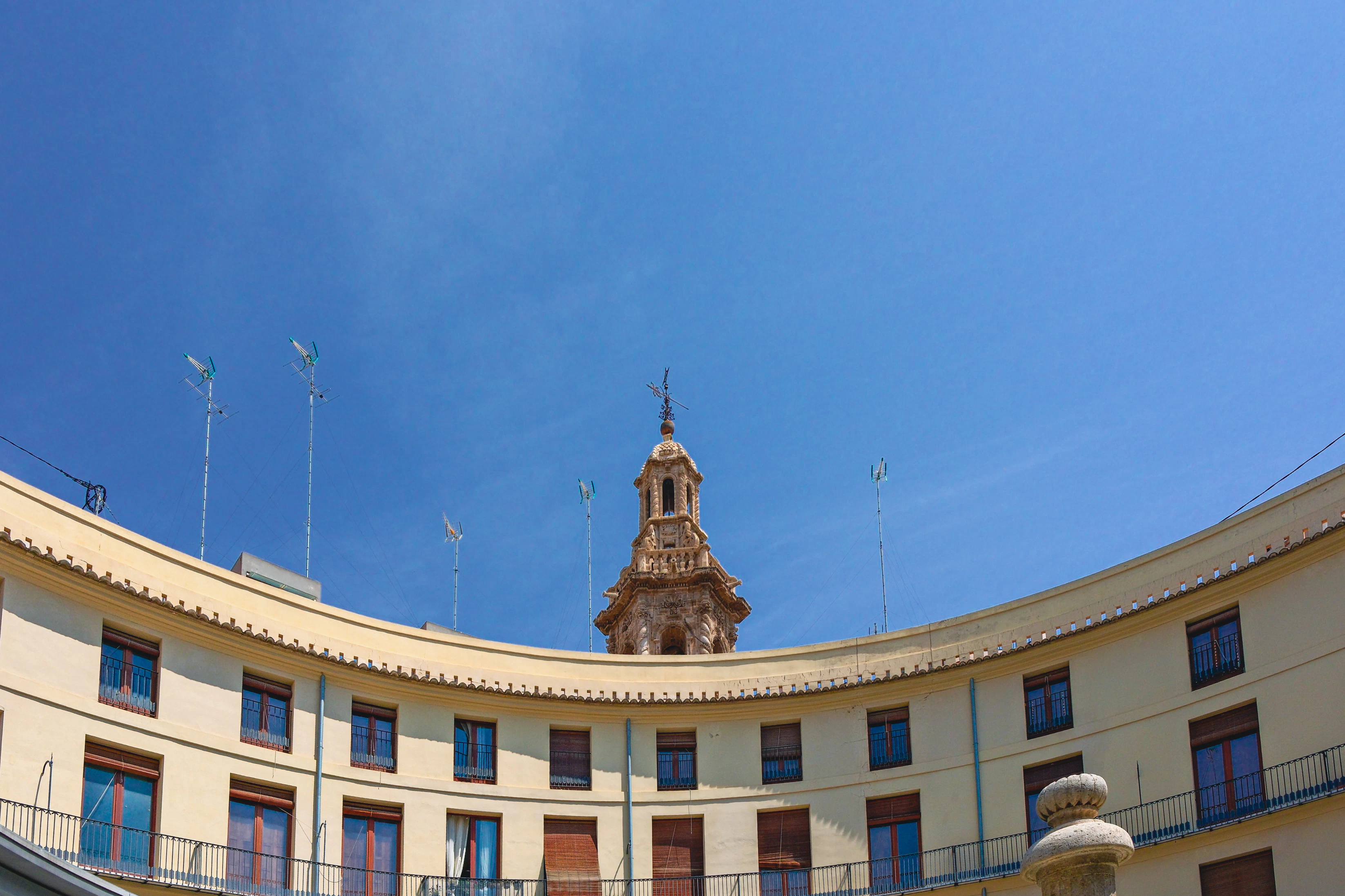 Curved building with a distant clock tower