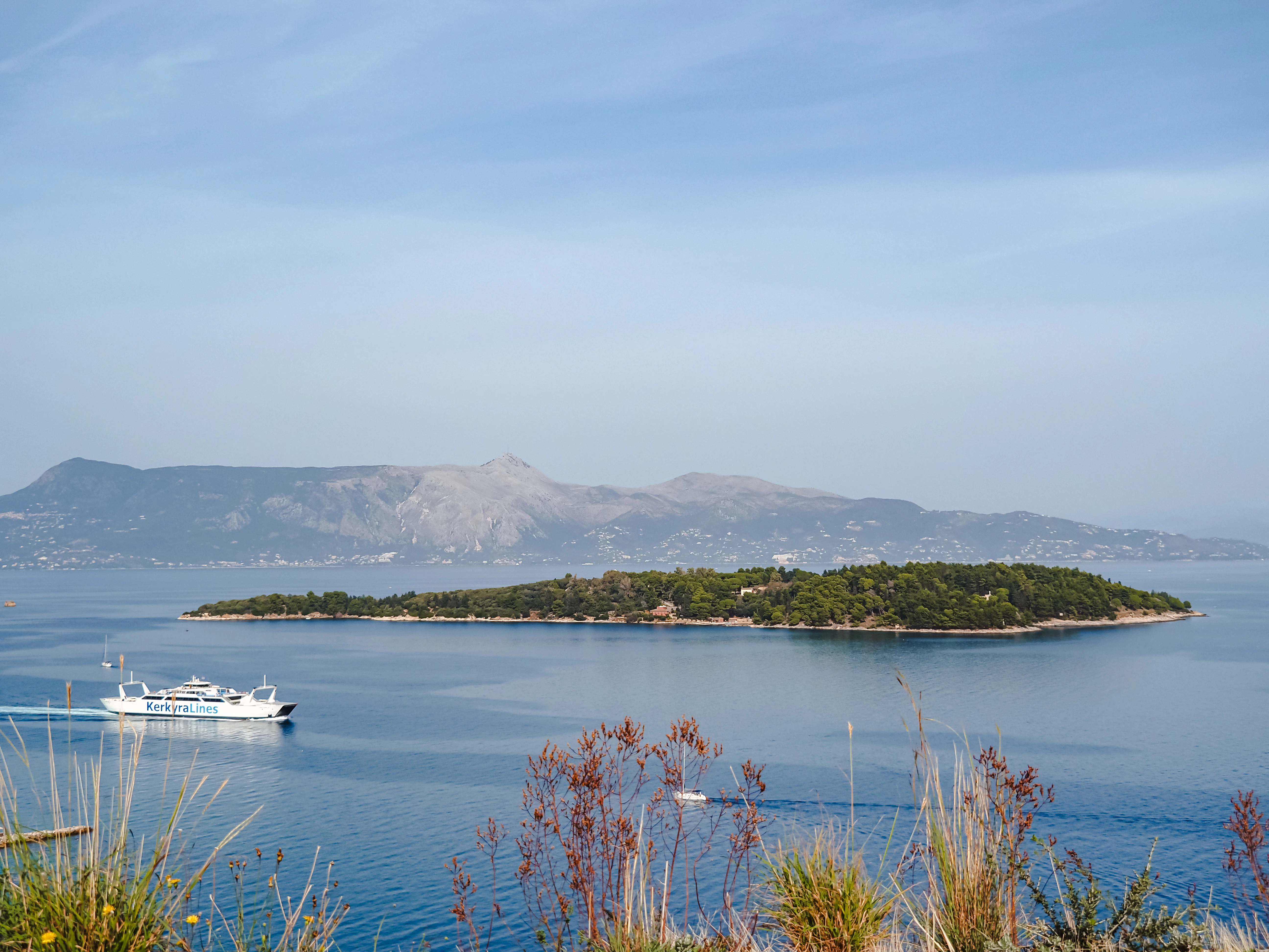 A boat is in the water near a small island