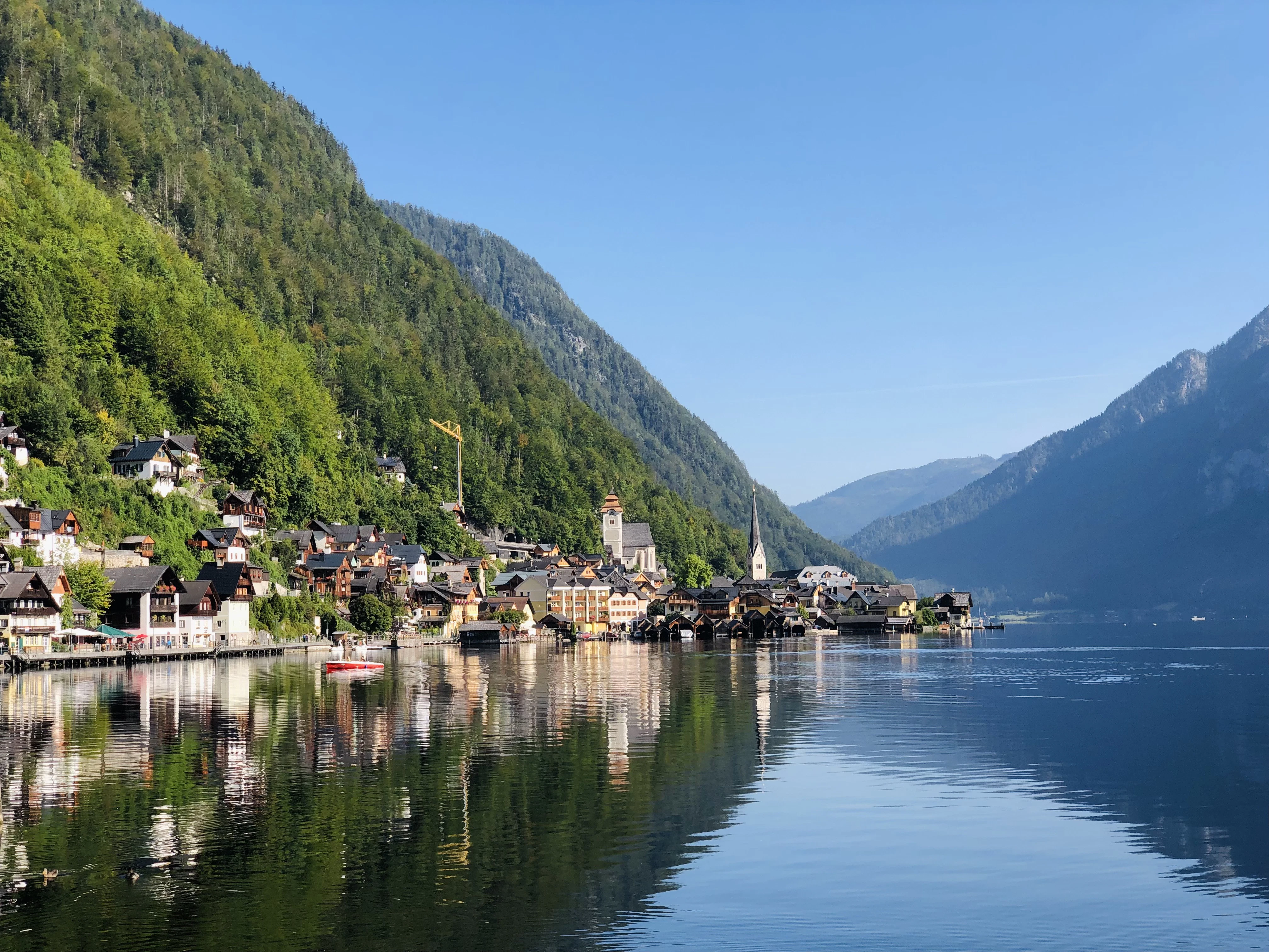 green mountain beside body of water during daytime