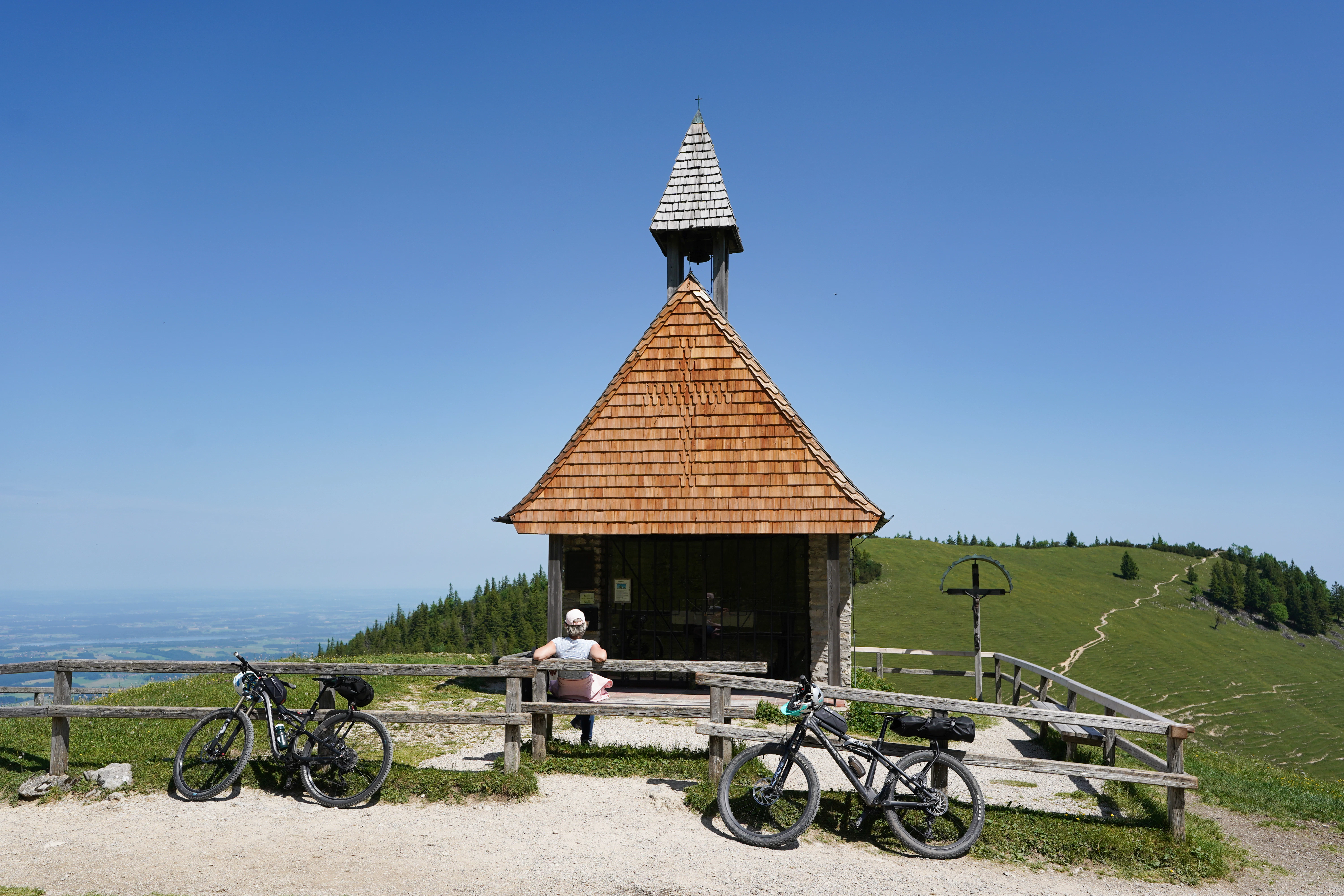 Small wooden chapel on a mountain with bicycles
