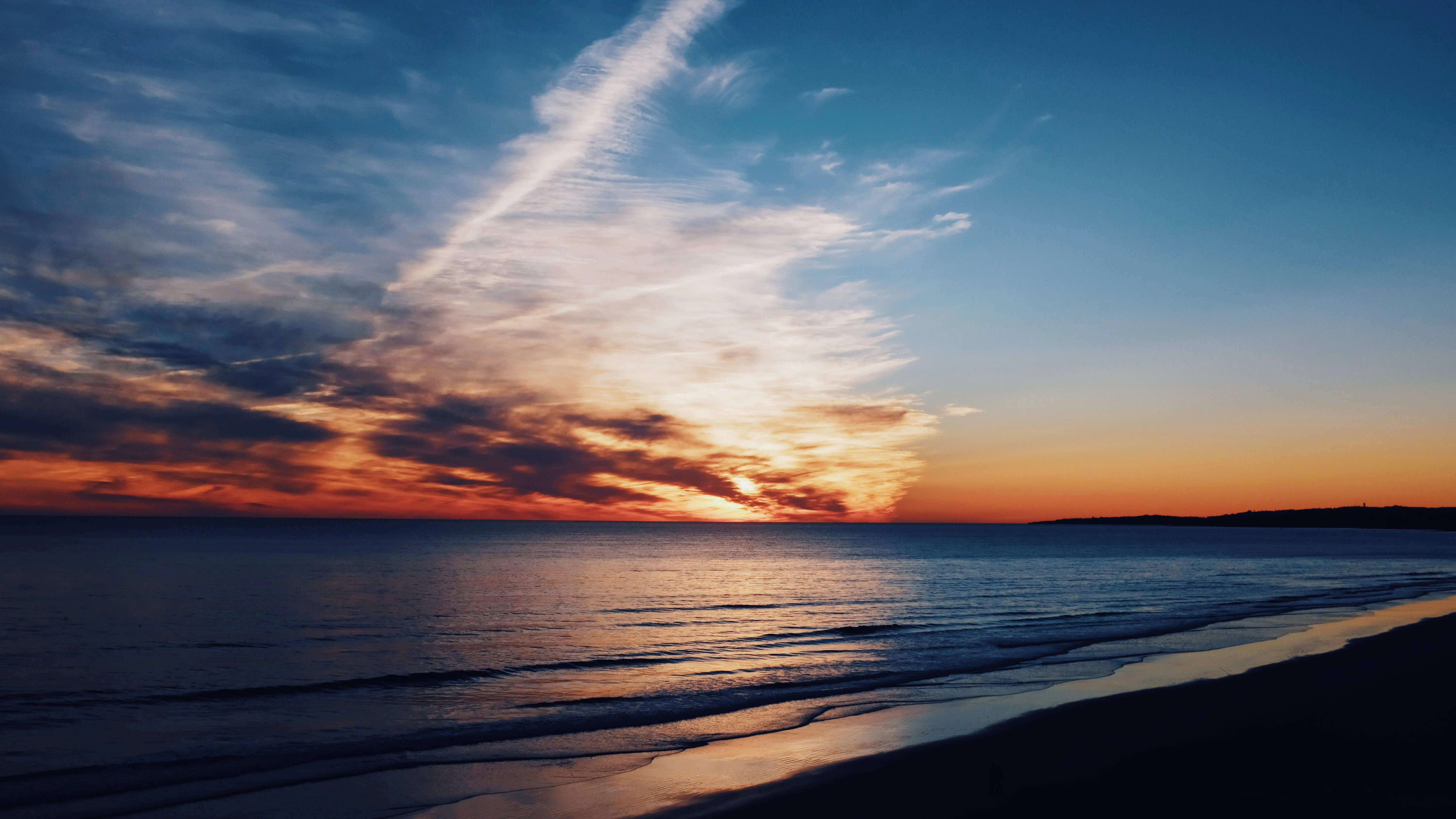 silhouette photography of body of water under sky